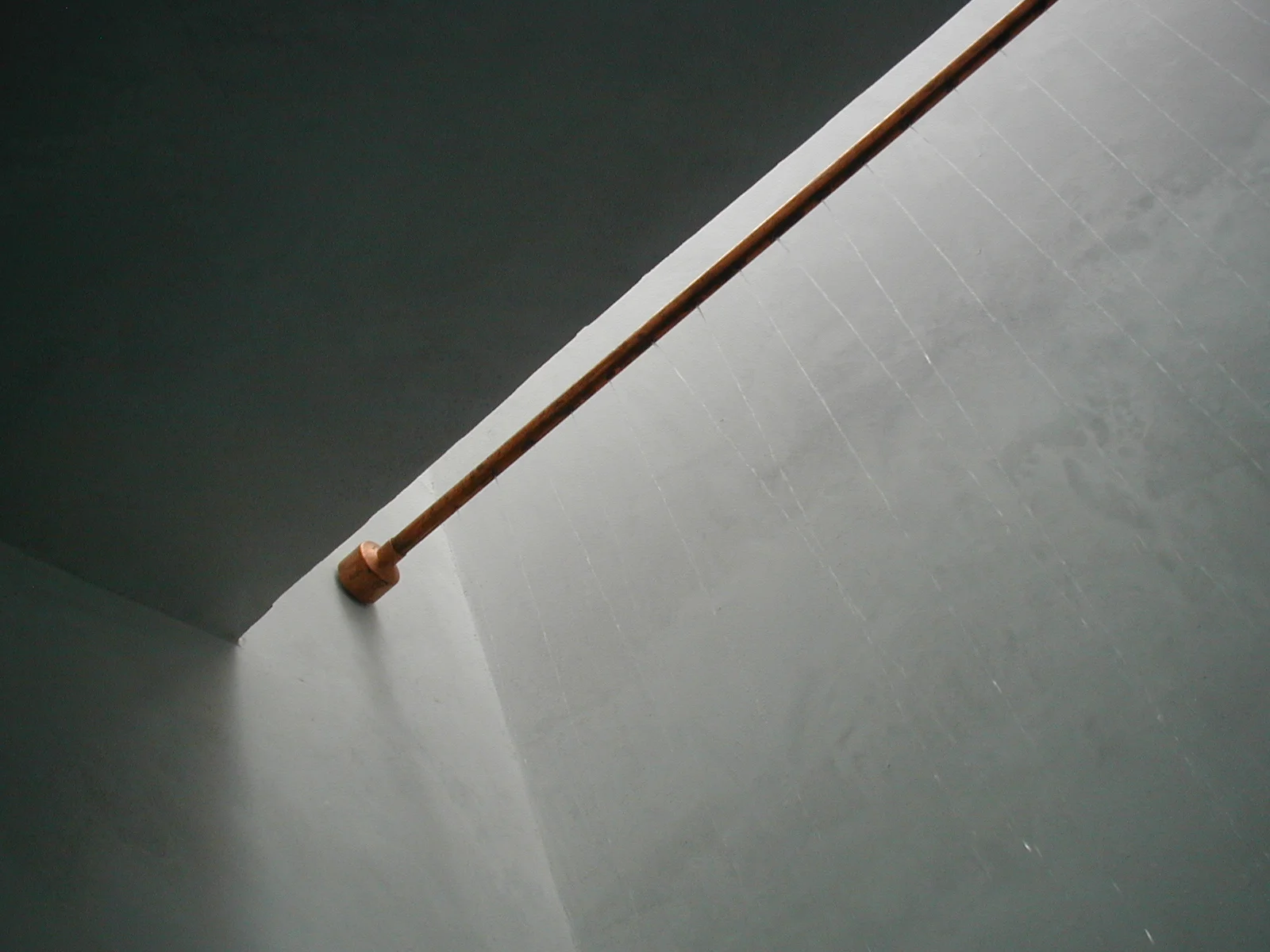  ‘Rain’ falls from perforations in a copper tube mounted up in the skylight well of this shower. 