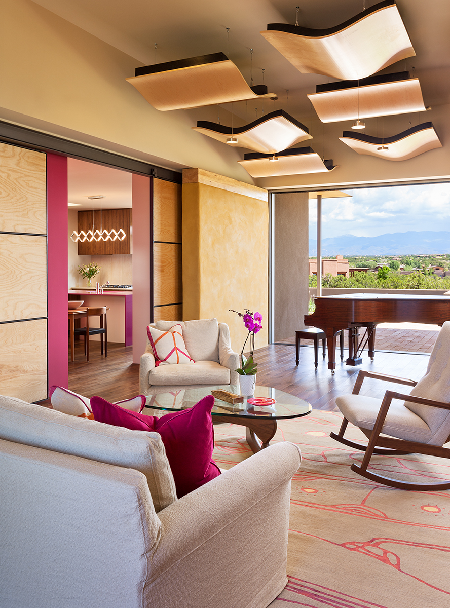 Designed as an occasional recital hall for retired opera singers and their musician friends, this living room fully opens to mountain views on one side and an enclosed courtyard on the other, thereby expanding the space for larger audiences when nee