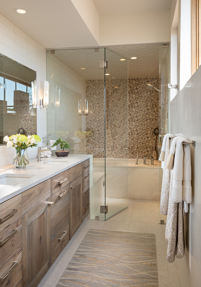 The counter material continues into the steam shower to form a bench and tub deck.