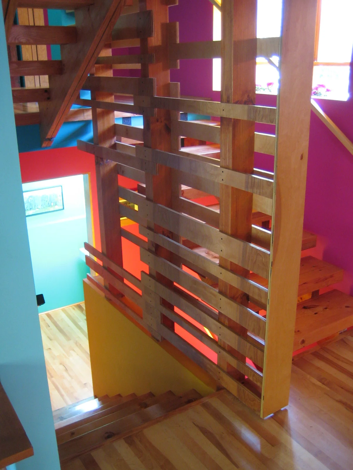  Two sheets of maple-veneer plywood have been sliced, pulled apart, and reconfigured to form this guardrail with the wood’s grain continuous up the height of the stairway. 