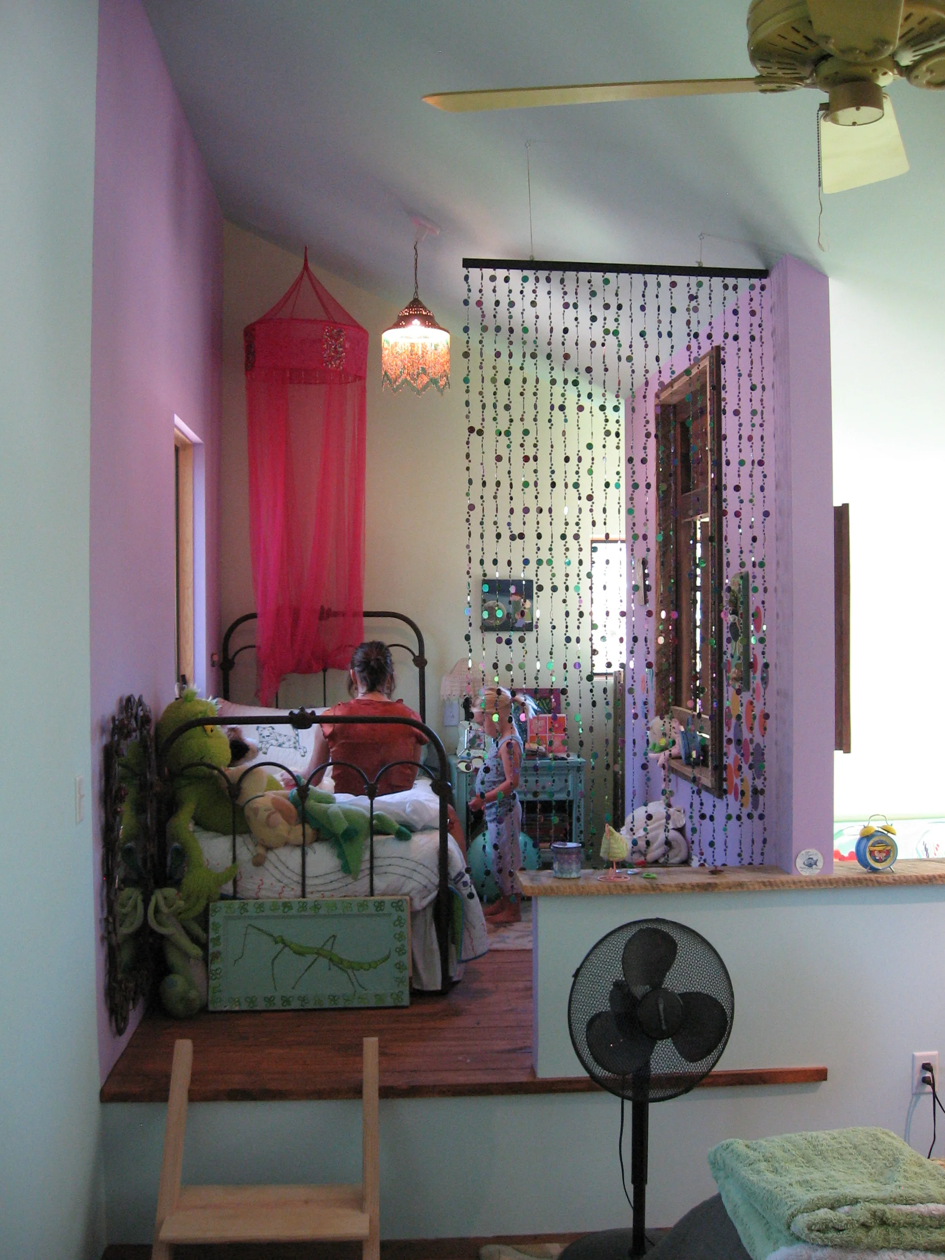  This cozy loft was designed for a young child to be a few steps up from her mother’s bedroom, both overlooking the living room and kitchen which features an indoor custom swing, of course. 