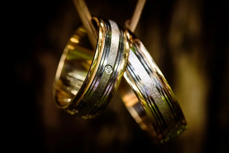 Two 14K weddings bands featuring different gold alloy colors and finishes combined in one piece.