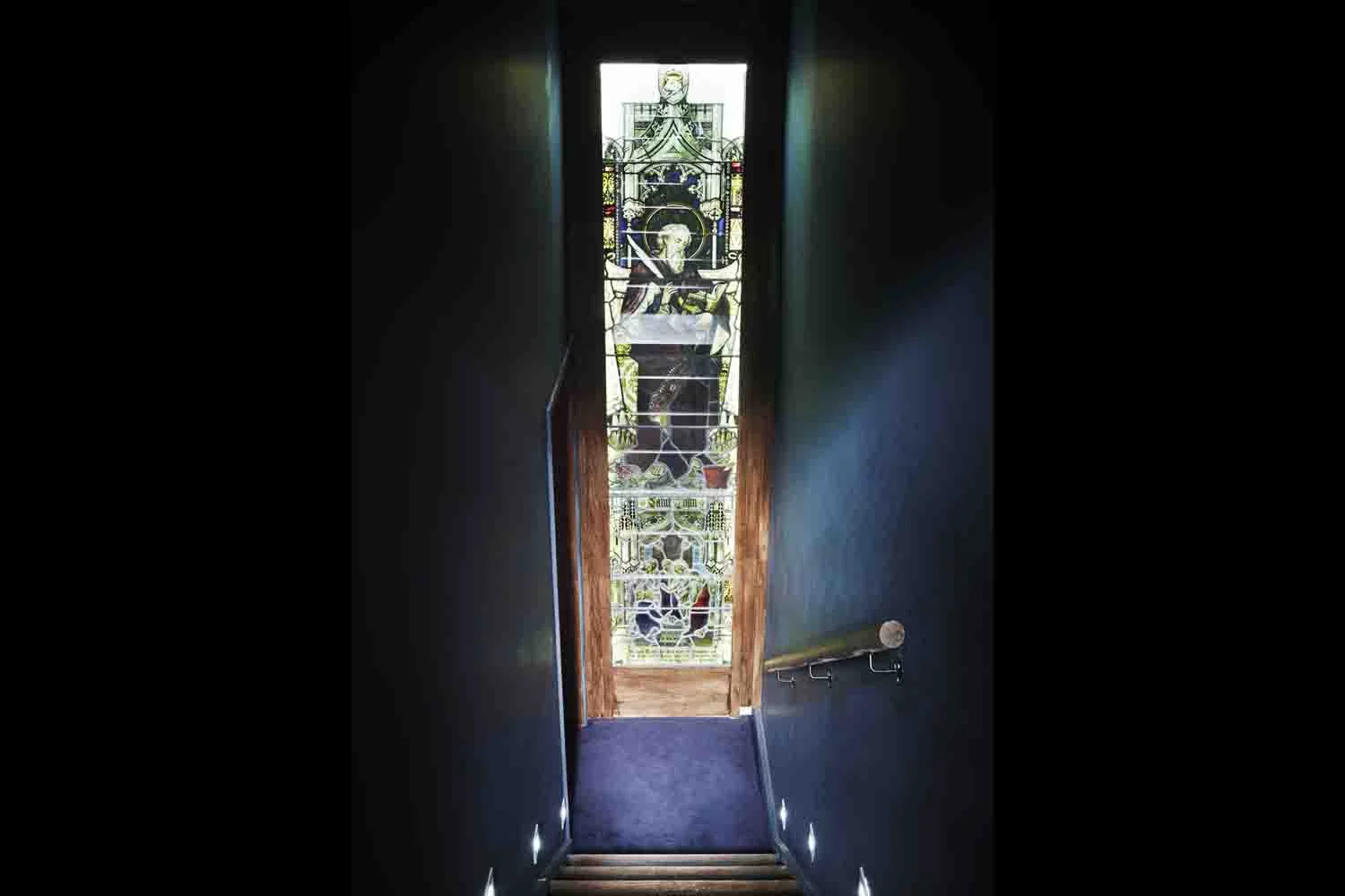 stairs to mezzanine stained glass .jpg