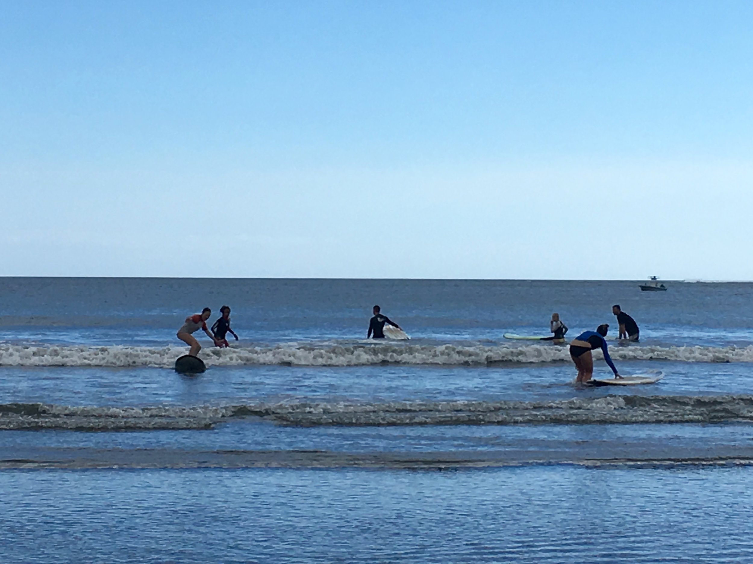 The crew out surfing Monday morning before the first day of work