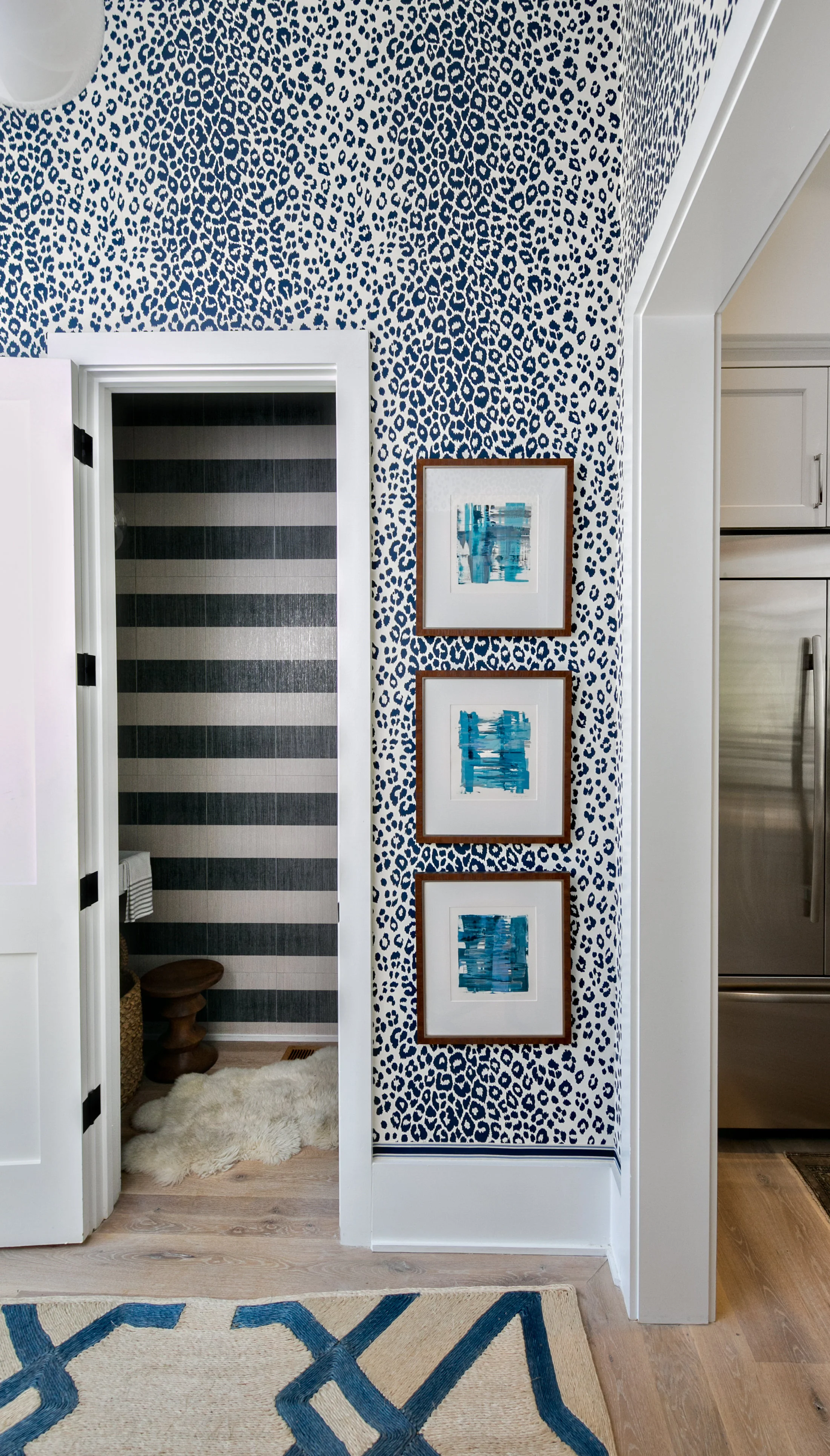 The wallpaper is Schumacher Iconic Leopard and the art is by San Francisco artist Chloe Meyer. 