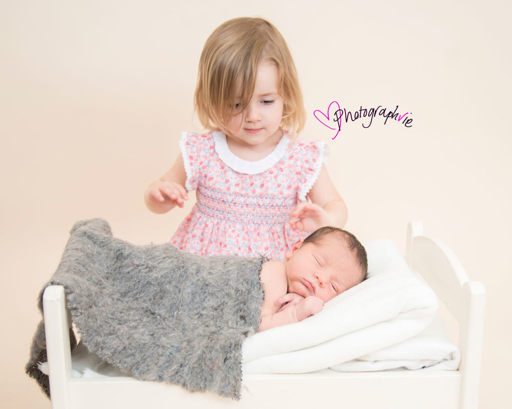 Newborn_Baby_photography_Ely_Cambridgeshire-baby-finley-with-sister-on-bed.jpg