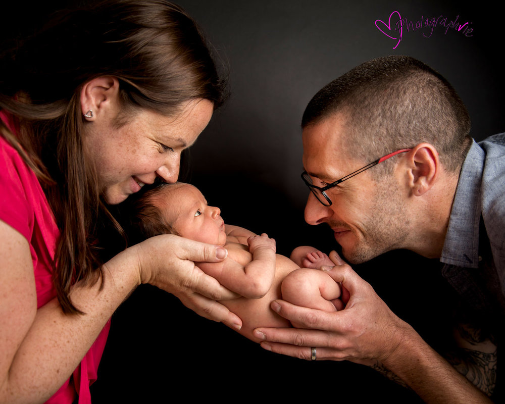Newborn_Baby_photography_Ely_Cambridgeshire-baby-finley-black-backdrop-close-up-of-parents-and-baby.jpg
