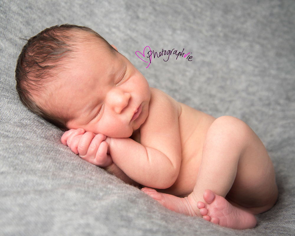 Newborn_Baby_photography_Ely_Cambridgeshire-baby-finley-asleep-on-gre-backdrop-with-cord.jpg