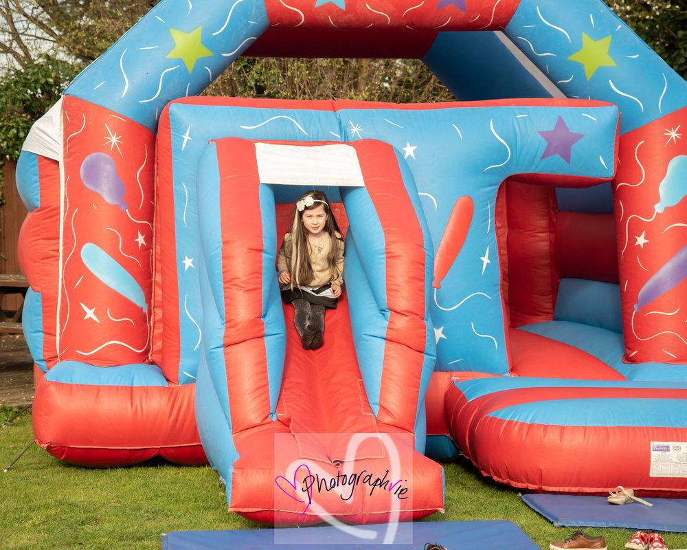 bouncy castle hire at soham wedding children playing outside photos by photographvie wedding photographer specialist