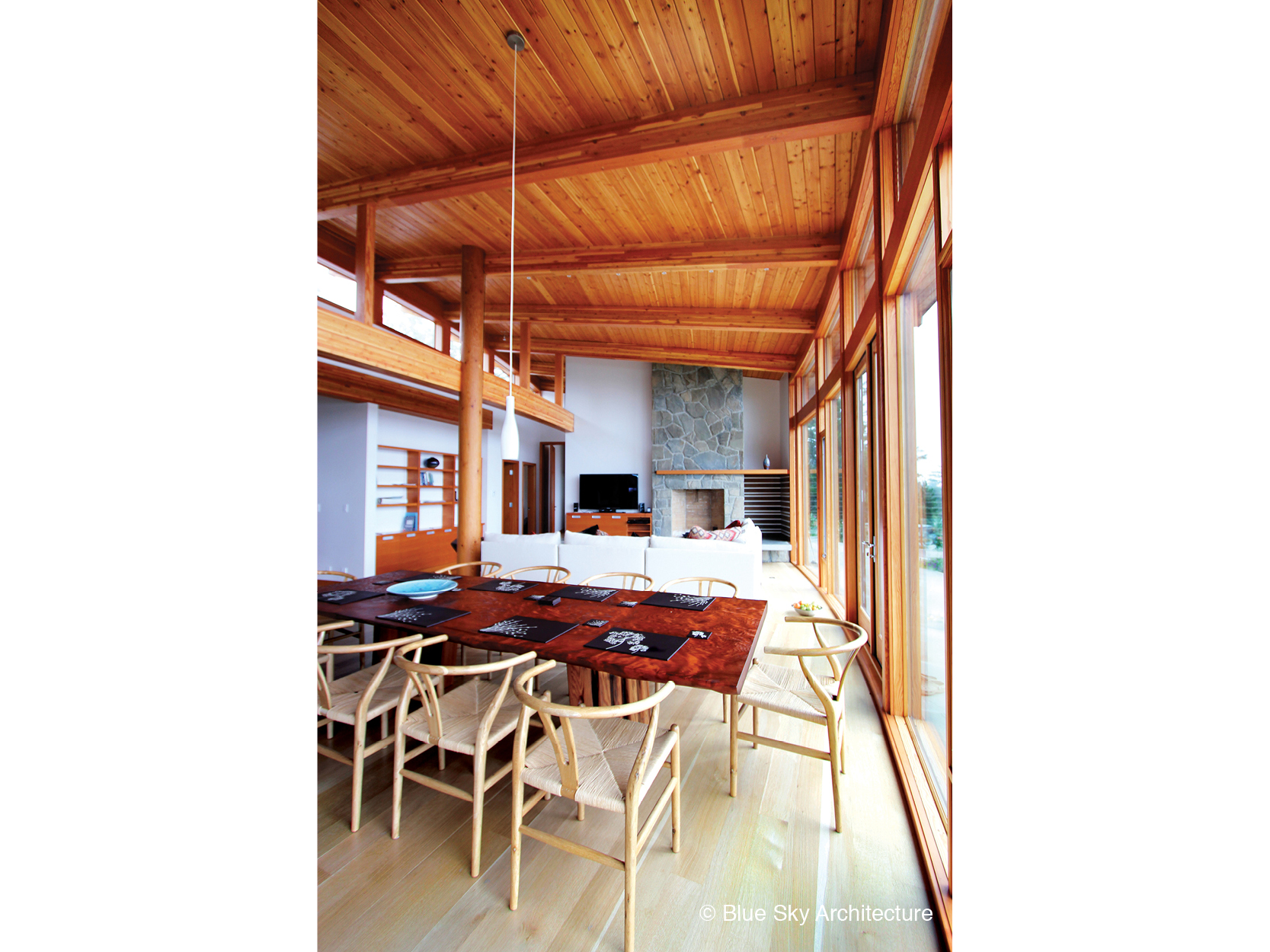 Open floor plan dining room and living room with post and beam construction