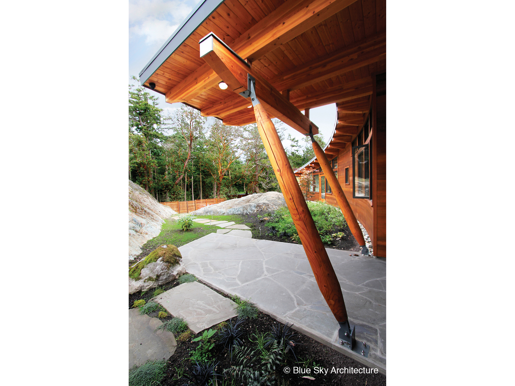 Heavy timber columns and beam on entryway of off-grid home