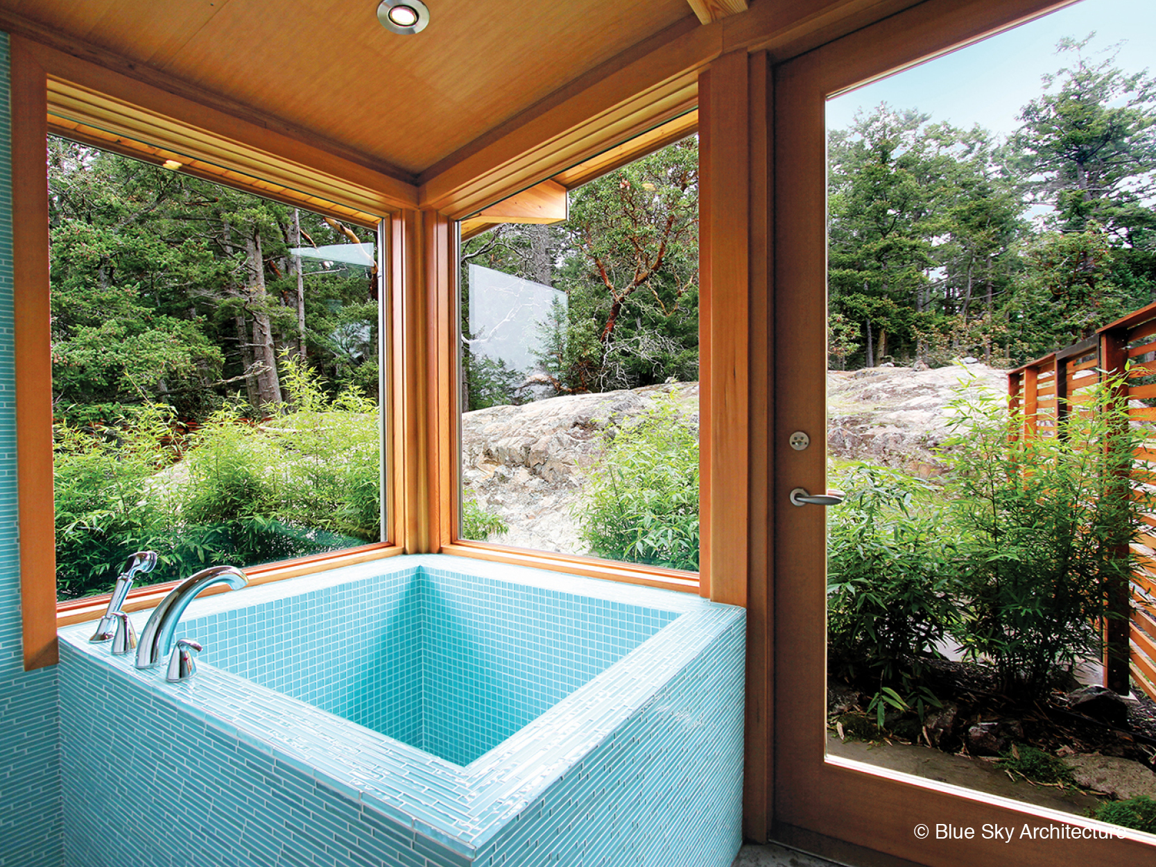 Solar crest bathroom with tiled Japanese soaker tub and forest view