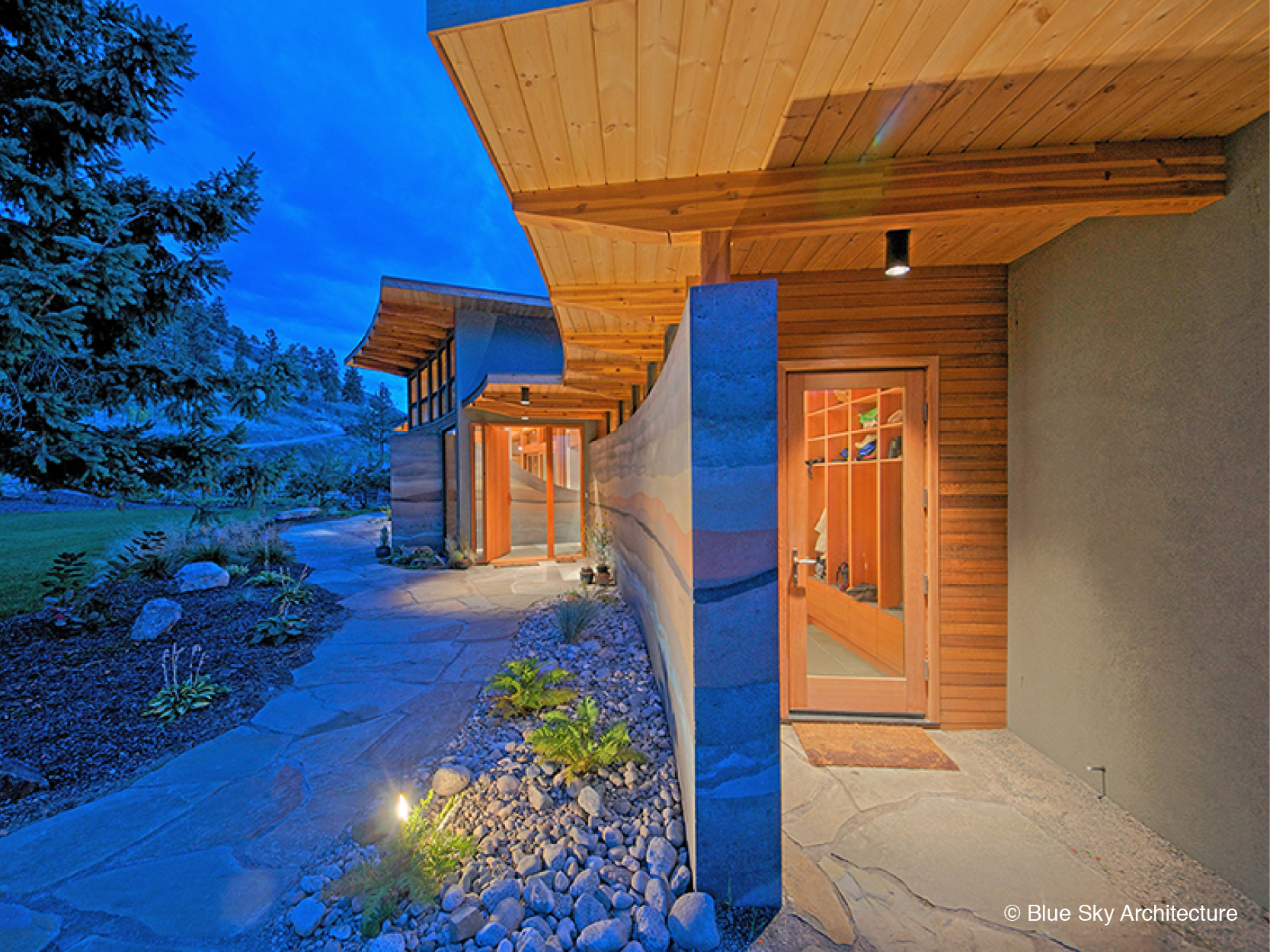 Rammed Earth Wall at entryway of lakefront architecture