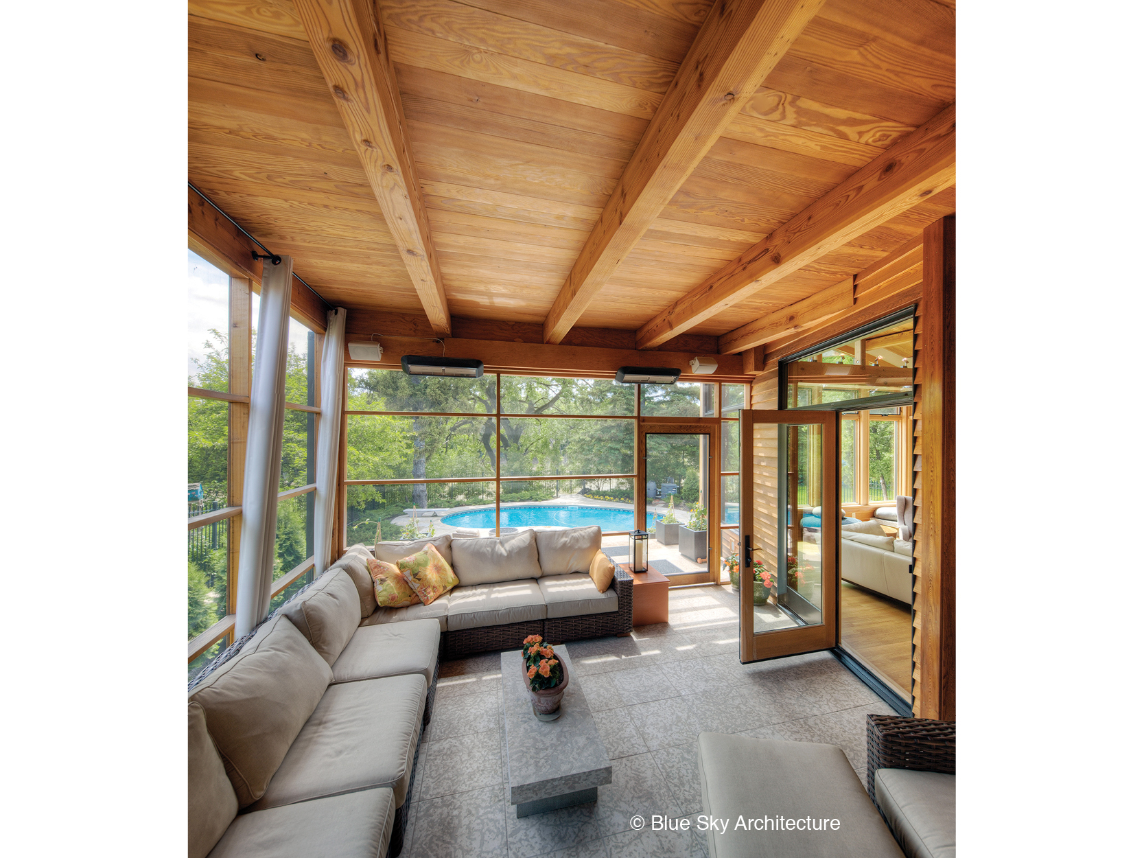 A screened-in porch with wood-framed ceiling