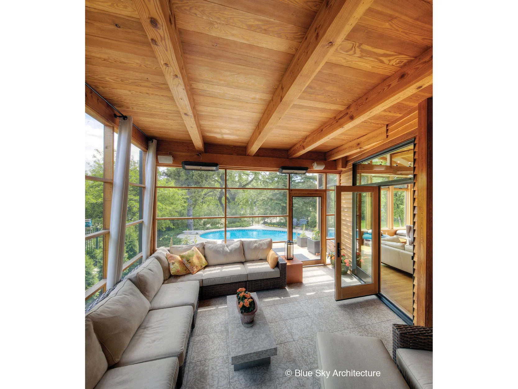 A screened-in porch with wood-framed ceiling