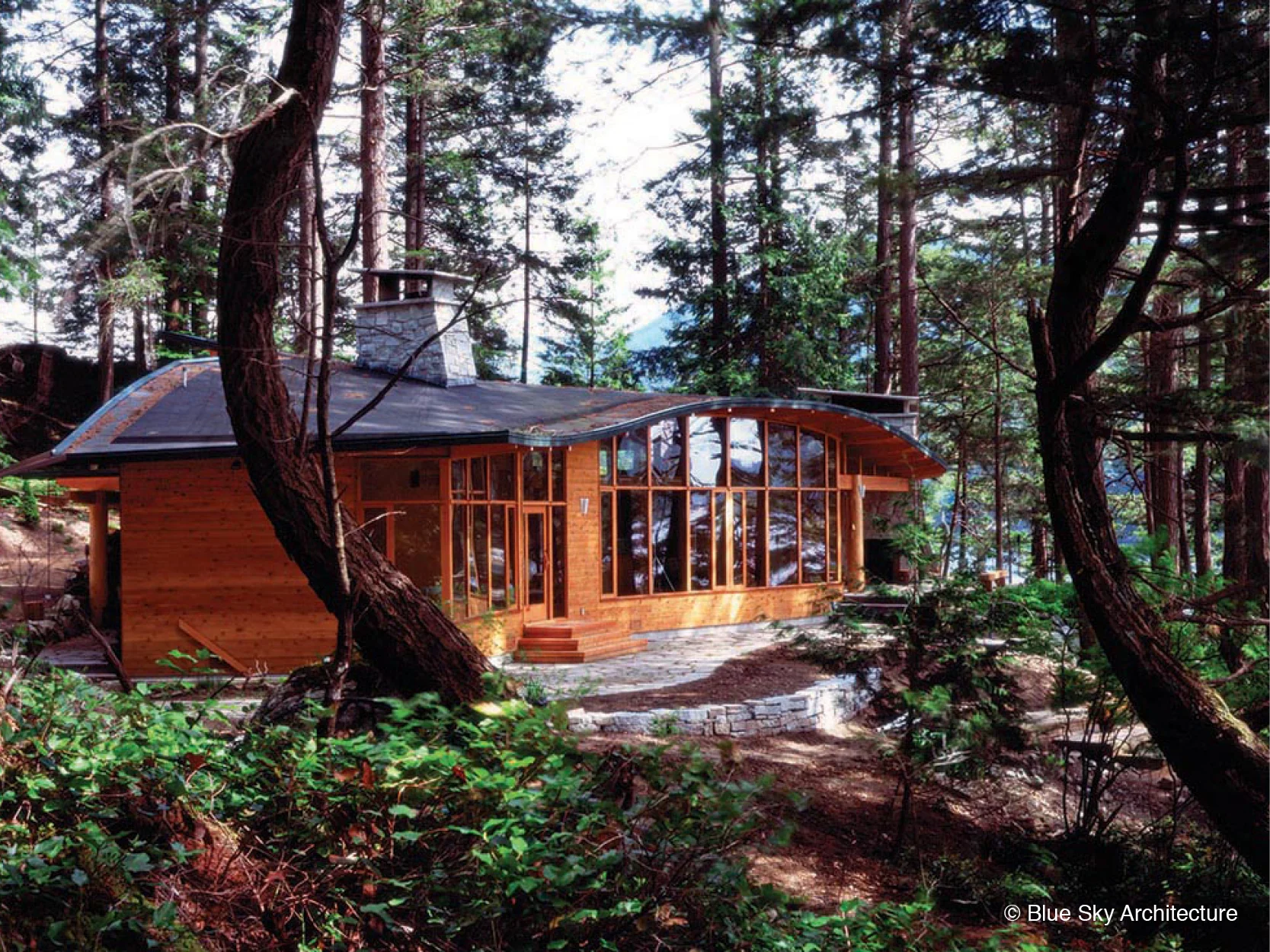 A wall of windows overlooking the terrace of the Deer Path House