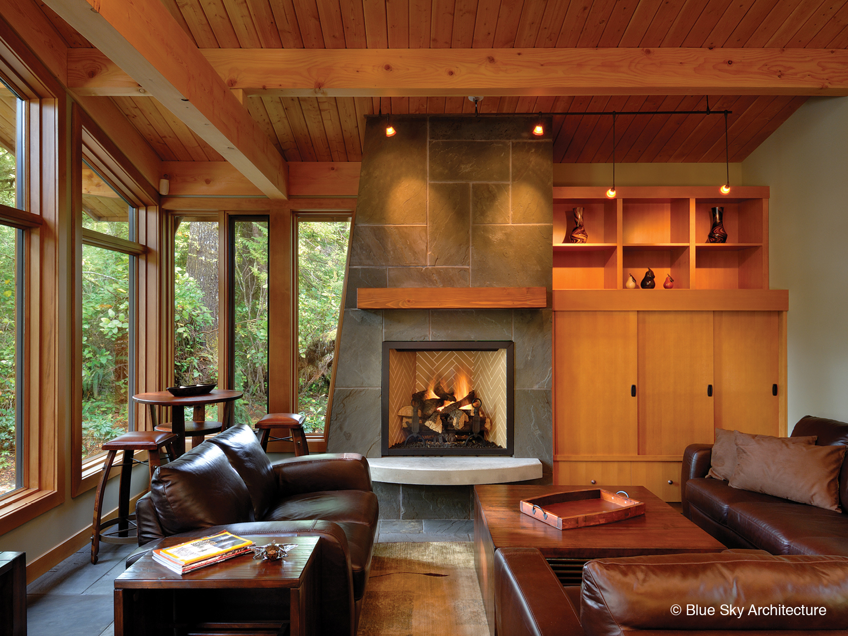 Stone fireplace in the all wood living room of Rainforest House