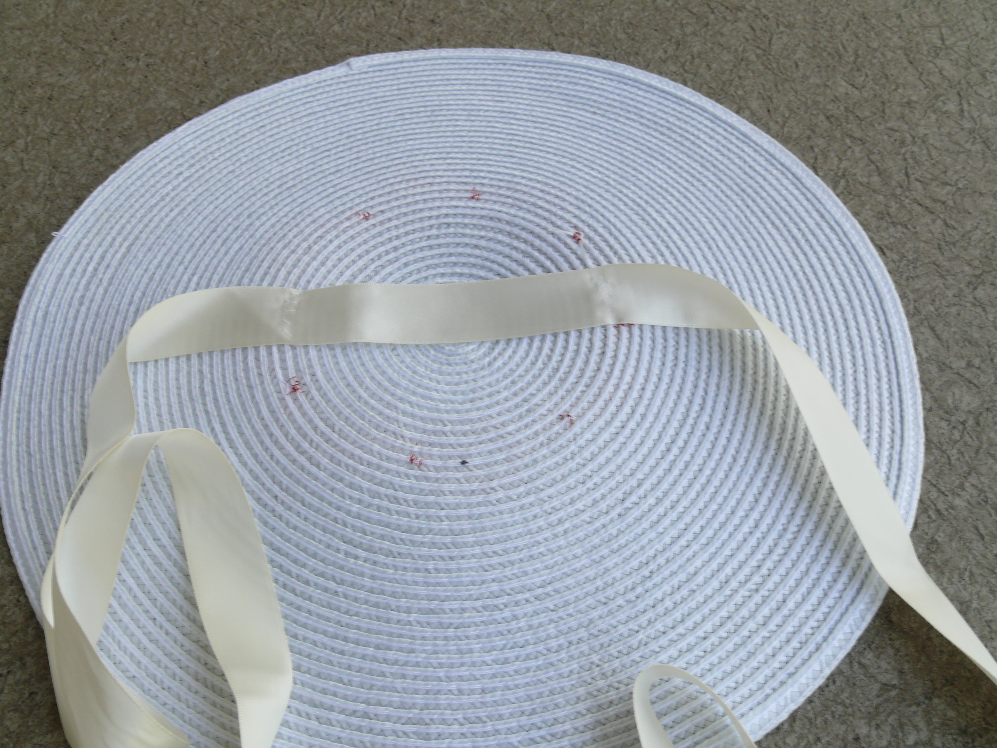 I sewed the ribbon to about the same diameter as the ribbon puffs on the topside, so the hat wouldn't curve down too much when worn.