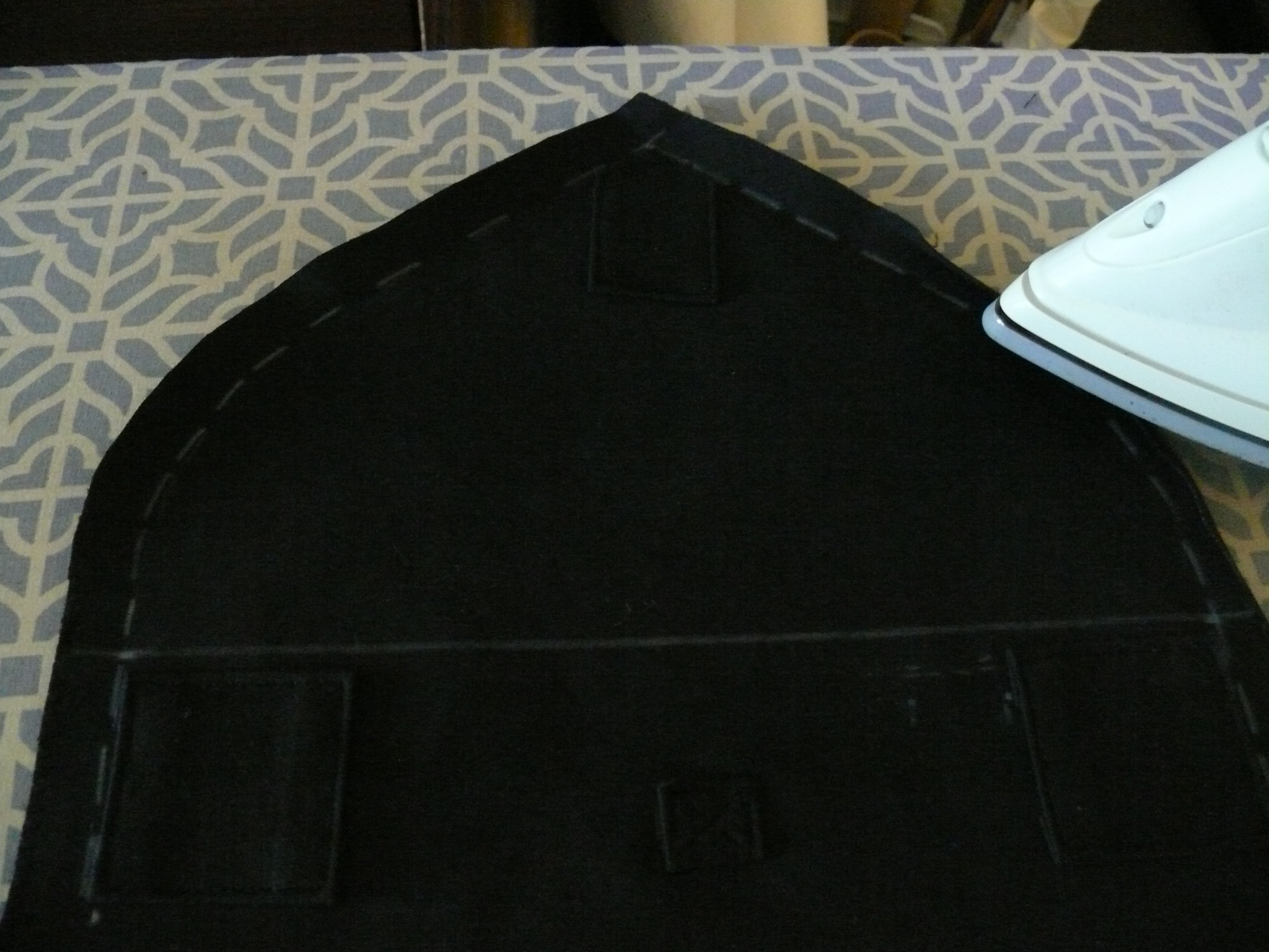 Preparing to hem the foldover extention using a 5/8" ( 1.5 cm ) seam allowance folded double.