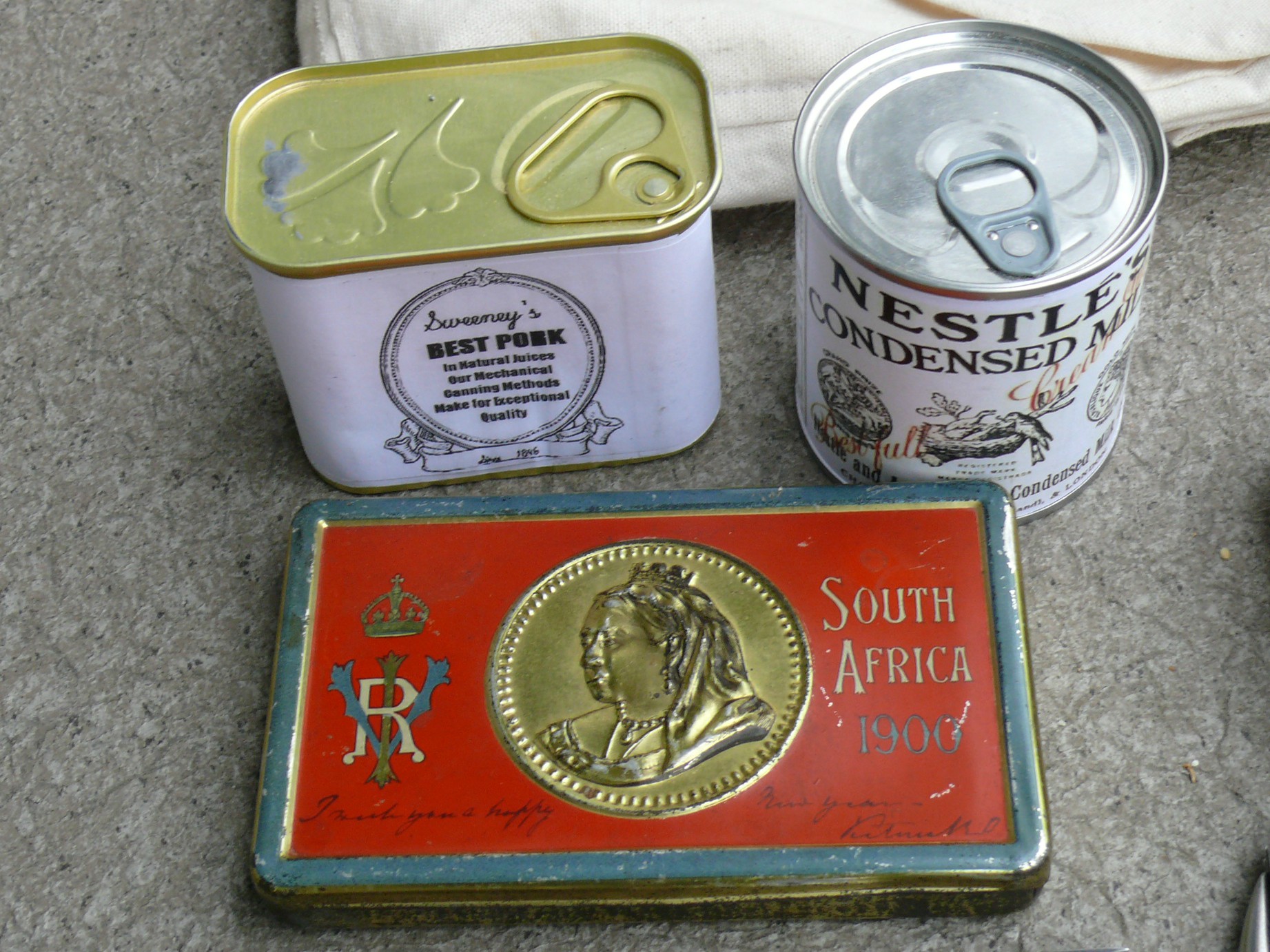 The chocolate tin is an original from the Boer War, the other tins are modern with reproduction labels. The pull tabs are not period correct.