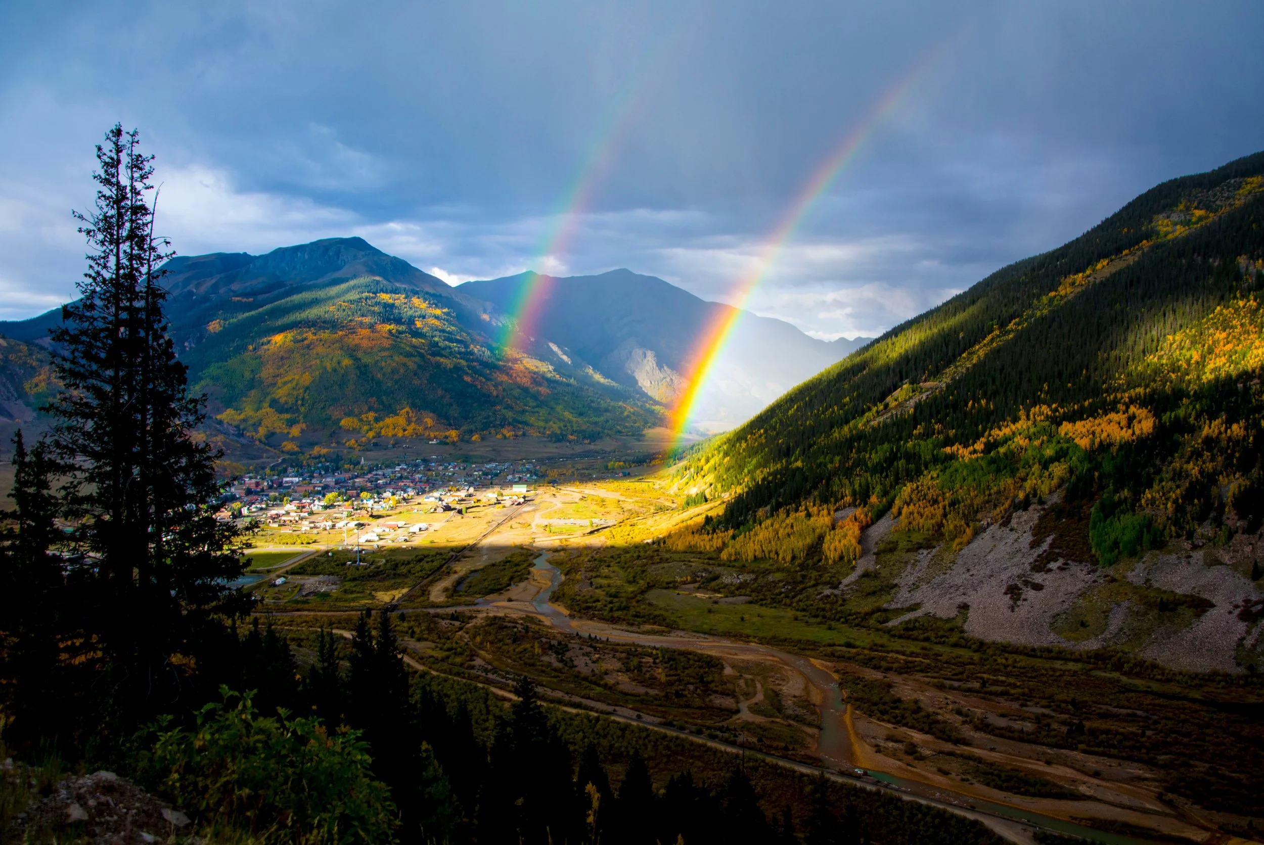 Double rainbow arching over a mountain valley