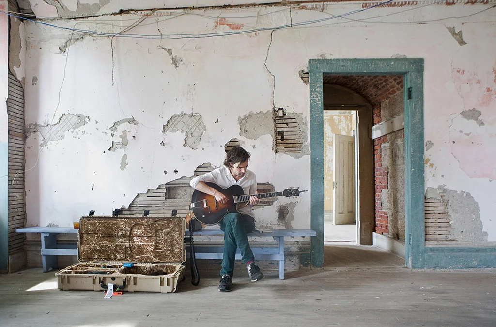 Brad Barr of The Barr Brothers plays guitar during a quiet moment inside Fort Adams.