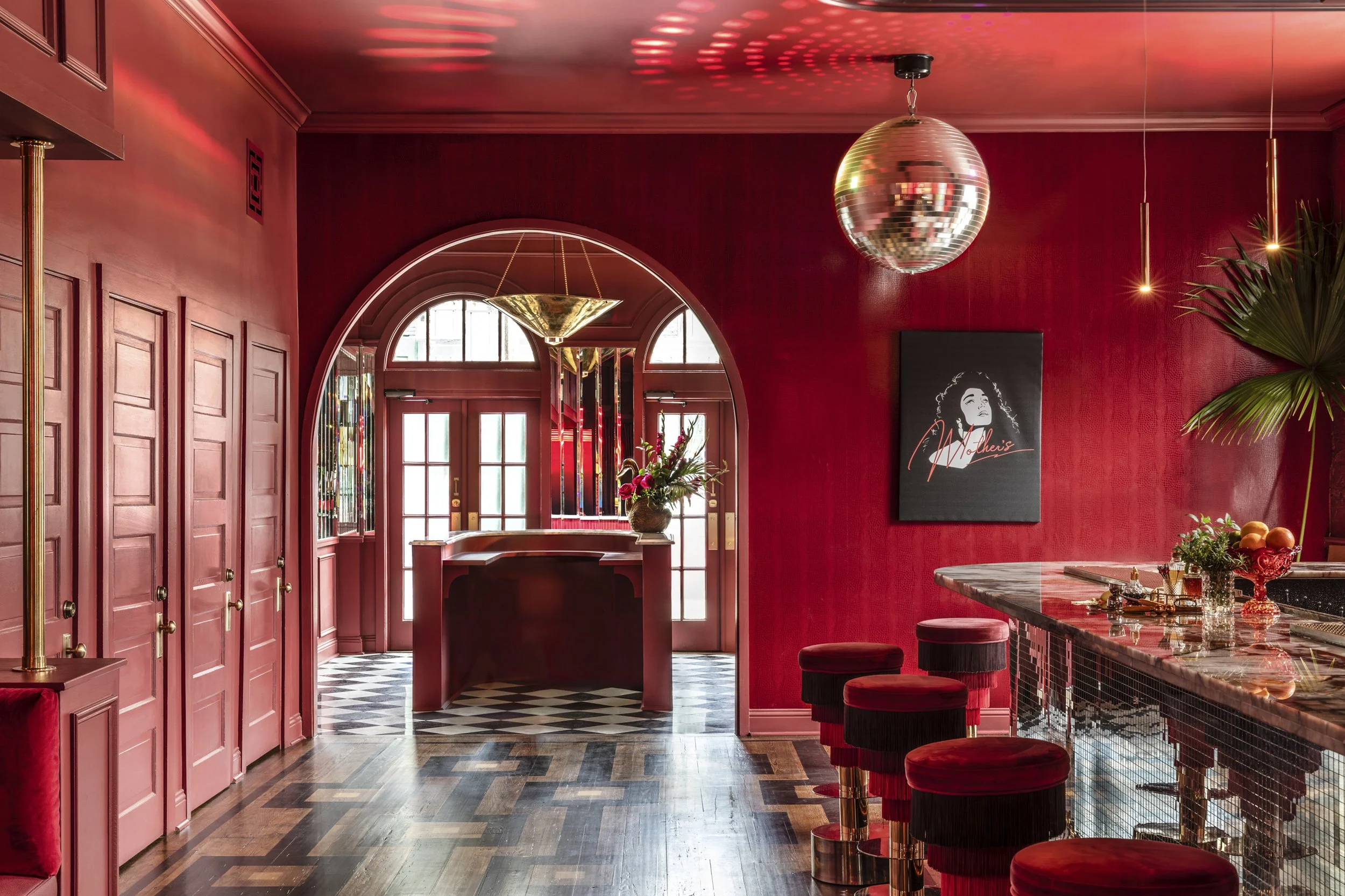 Arched entry, disco ball and fringed velvet bar stools at Mother’s, Baton Rouge