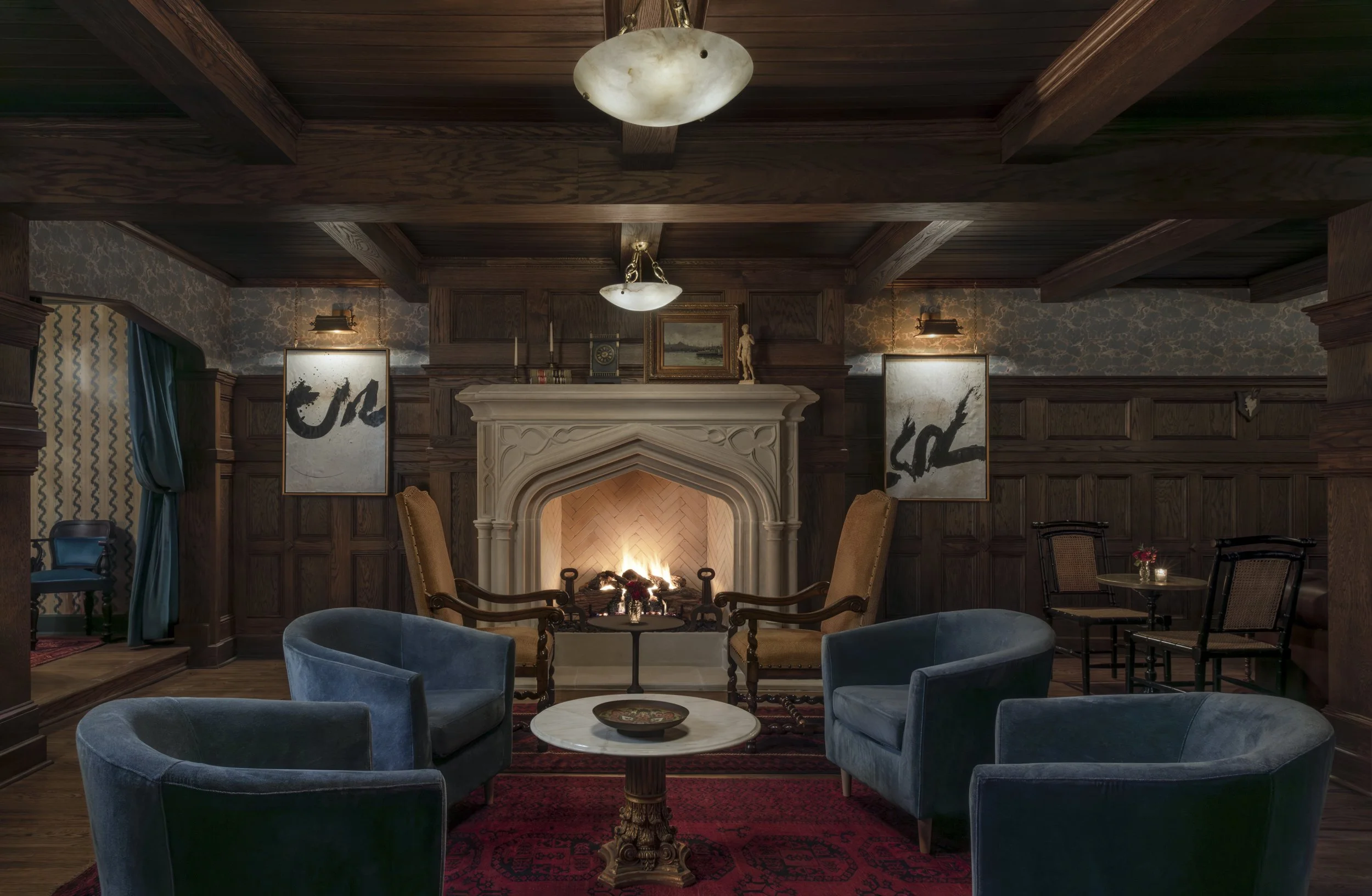 Carved stone fireplace and blue velvet chairs in the wood-paneled lounge at The
Colonel’s Club, Baton Rouge