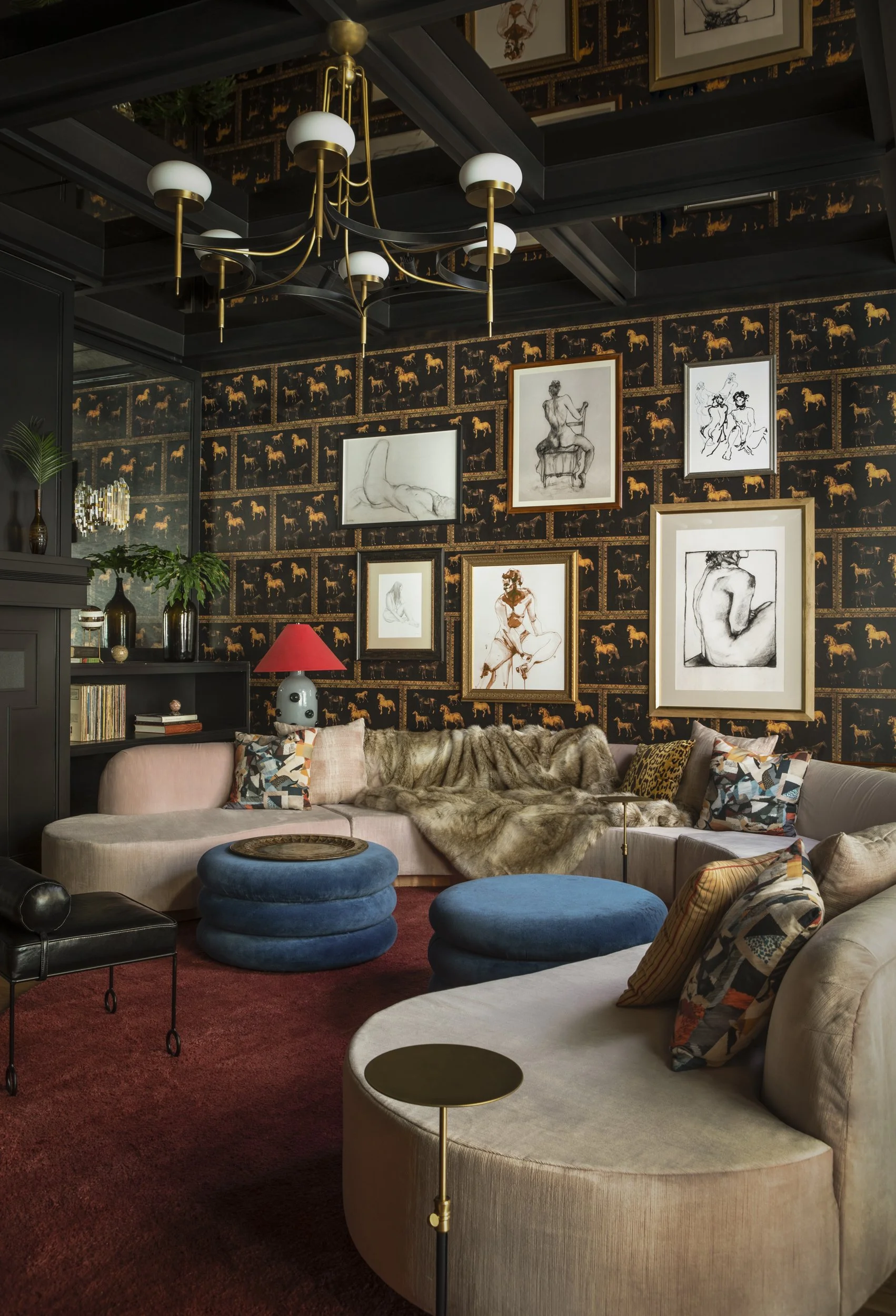 Lounge with black horse wallpaper, salon-hung figure drawings, curved sectionals and oxblood carpet at Virgin Hotels New Orleans