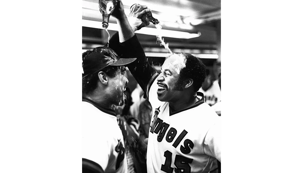  Bavasi signed future Hall of Famer Reggie Jackson to the Angels, shown here with Ron Jackson (R) celebrating the team’s second AL West Division title. 