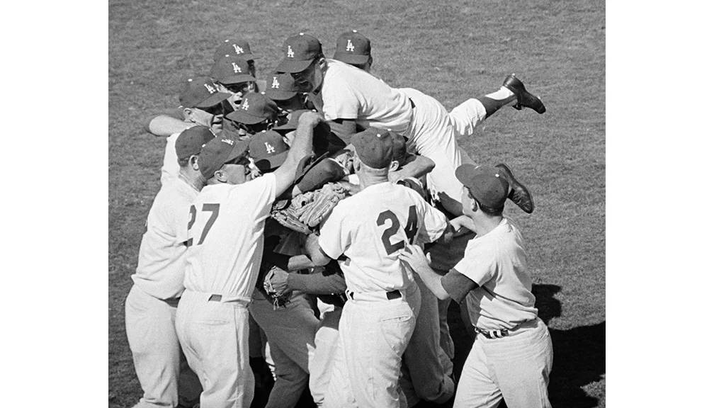Los Angeles Dodgers win the World Series Teammates all but bury Sandy Koufax after he pitched them to a 2-1 victory, completing the Dodgers’ sweep of the Yankees for the World Series championship.