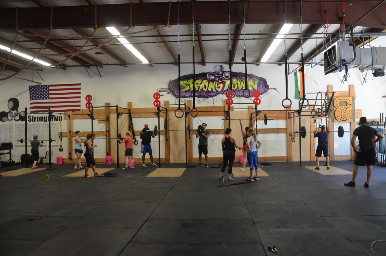 The 9:30 class working warming up their push press.