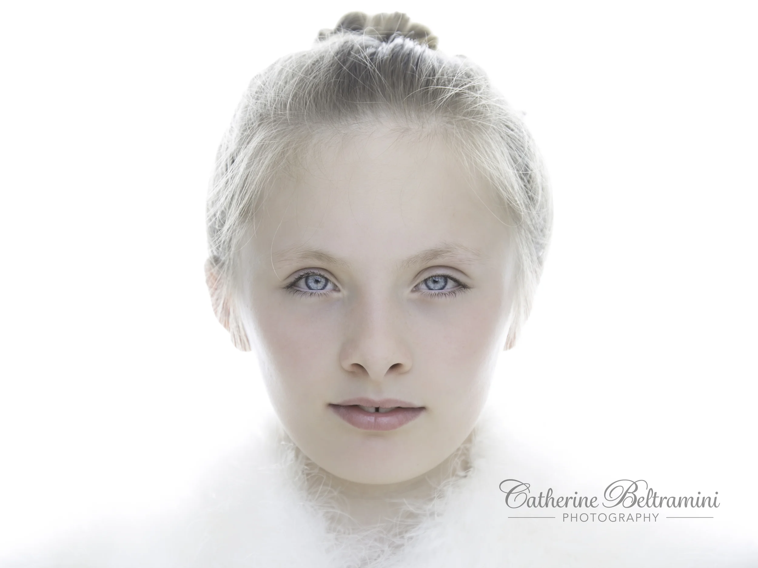 Snow queen high key portrait of a young girl.