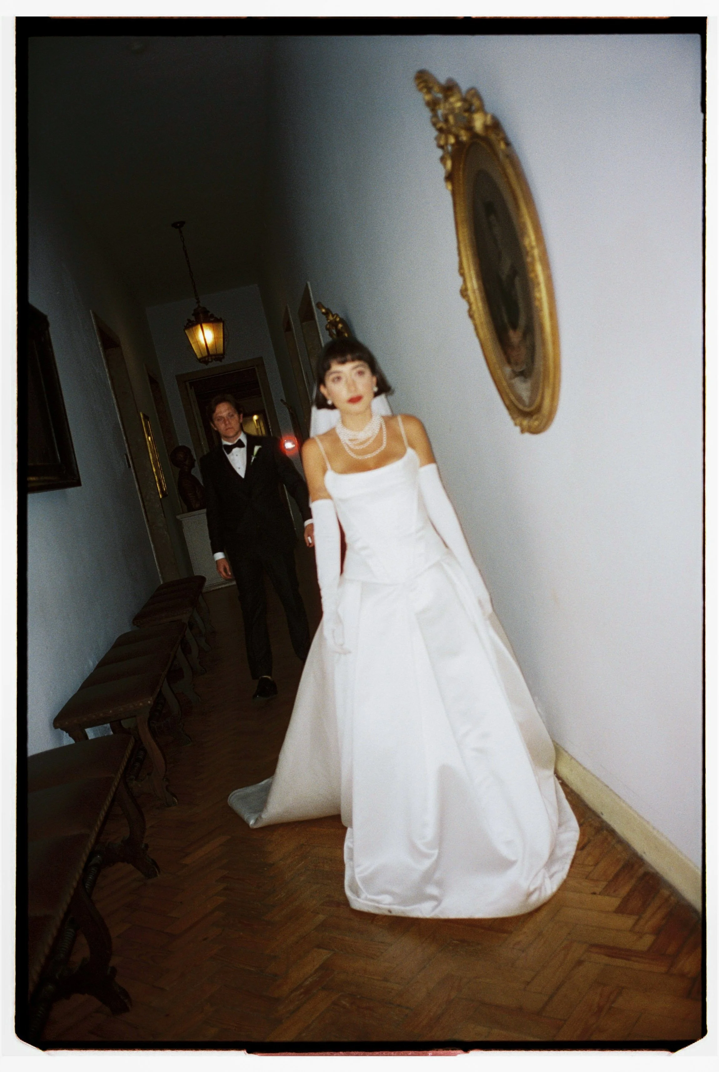 Real Bride Wears Pronovias Axelle Gown in hall with husband