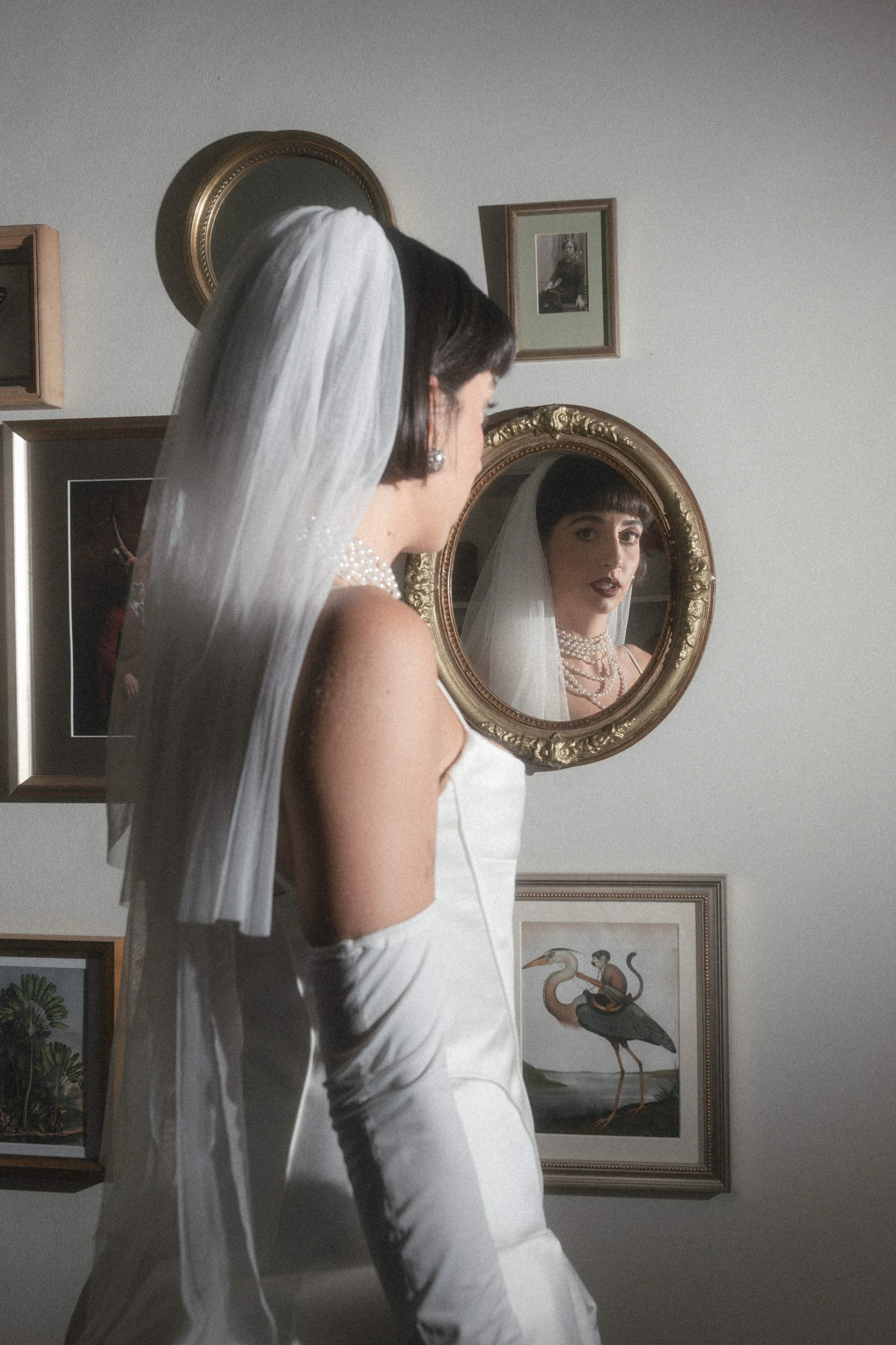 Real bride looks in mirror on wedding day