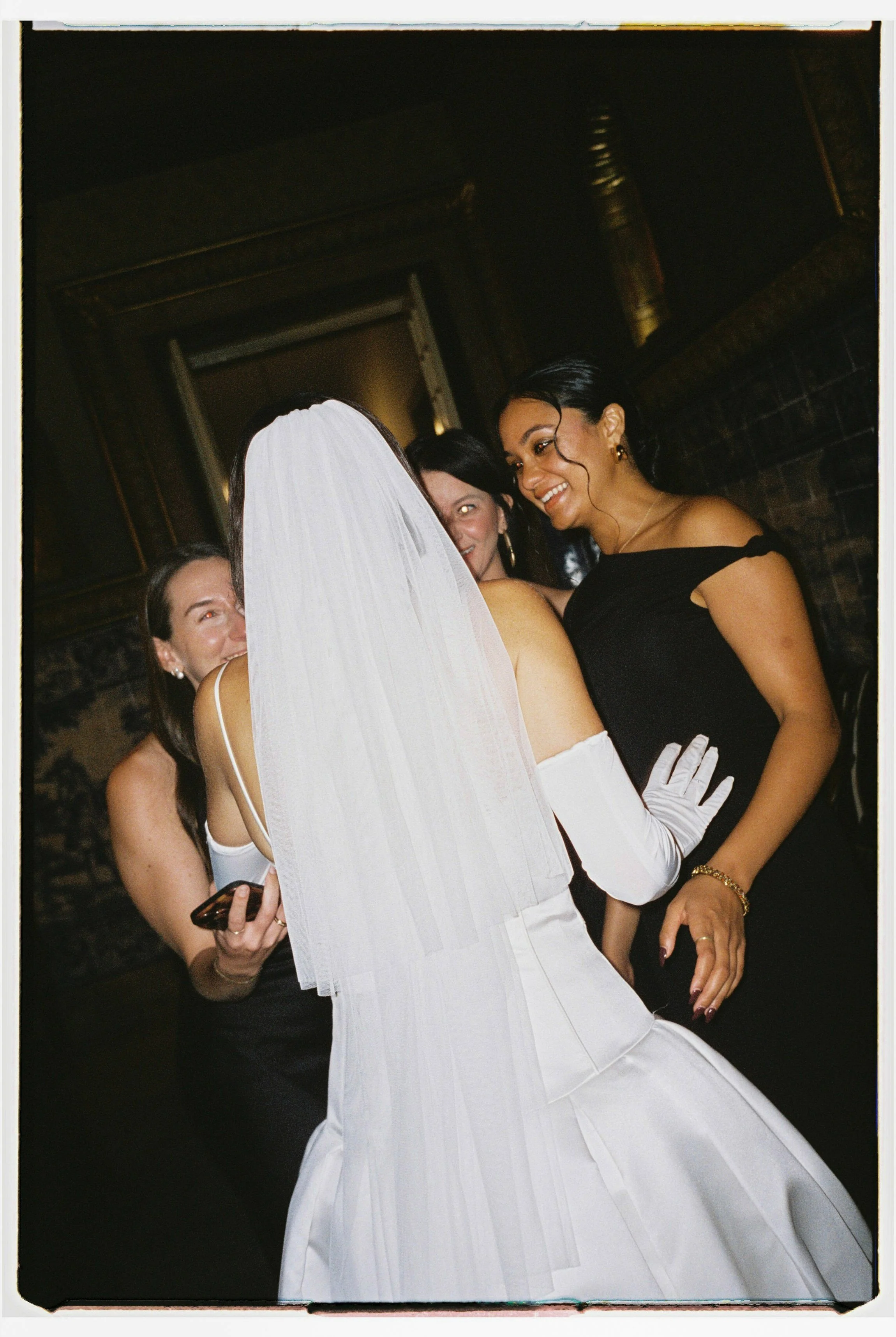 Real bride speak with friends on dance floor