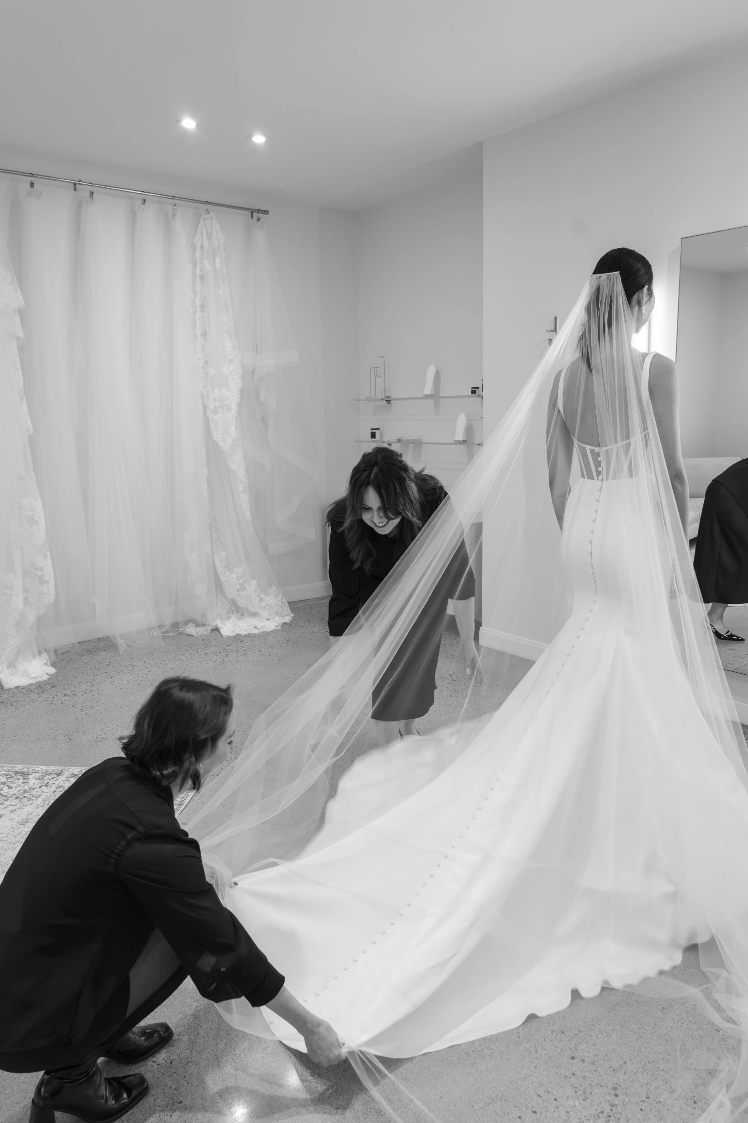 Bride and stylist trying on veils in her appointment
