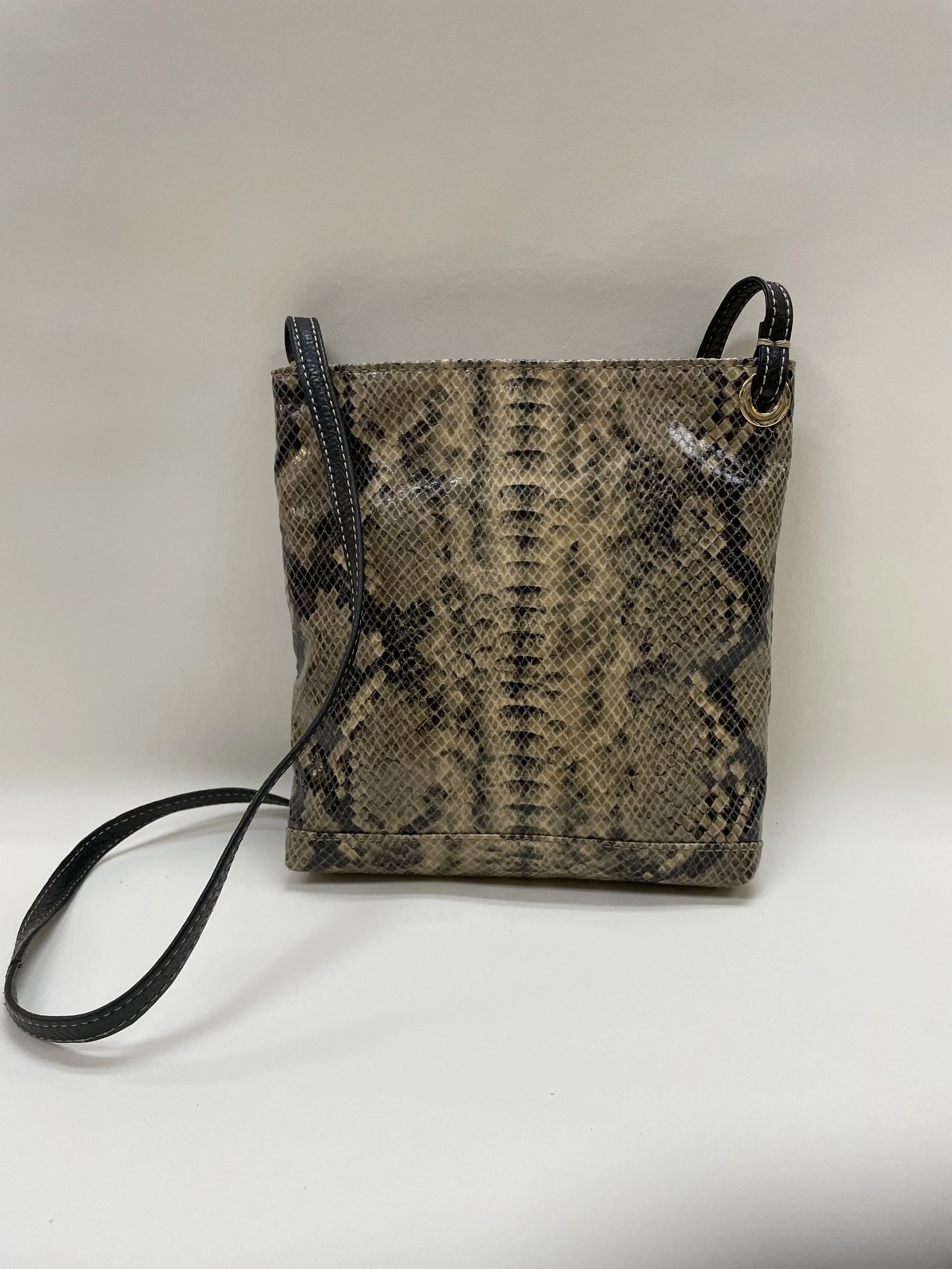 A snake print handbag with black leather handles and a black wrist strap, placed against a plain background.