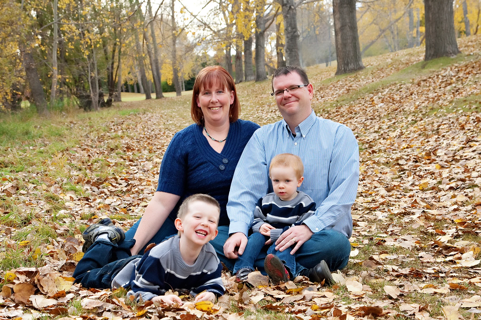 Family photo shoot in the Fall leaves at Confederation Park in Calgary