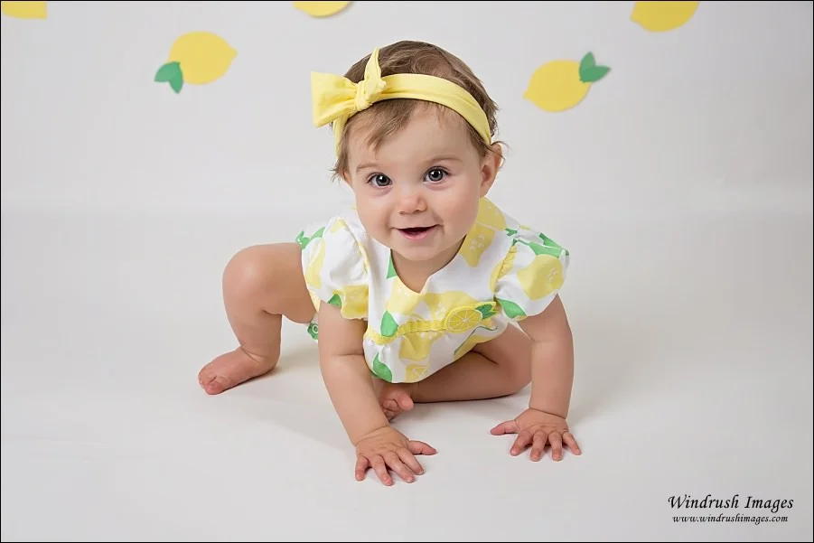 baby-girl-getting-ready-for-lemonade-themed-cake-smash-at-Windrush-Images-Calgary-portrait-studio