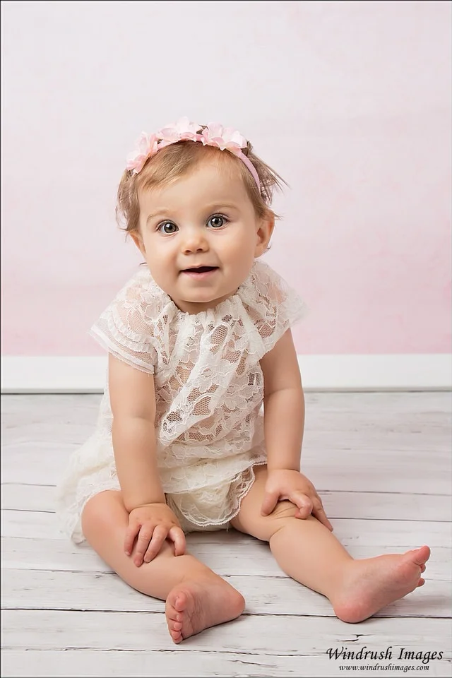 Calgary-studio-one-year-photography-session-little-girl-with-pink-background.jpg