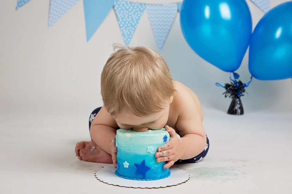 Cake-smash-photo-shoot-Calgary-boy-with-head-down-into-birthday-cake