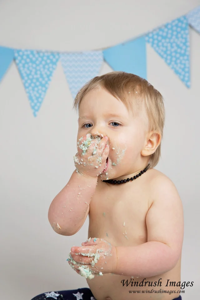 cake-smash-photographer-in-Calgary-close-up-of-baby-boy-with-cake-on-face.jpg