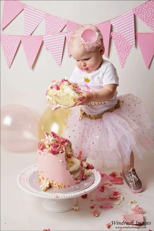 pink-and-white-cake-smash-with-balloons-Calgary-one-year-old-photos