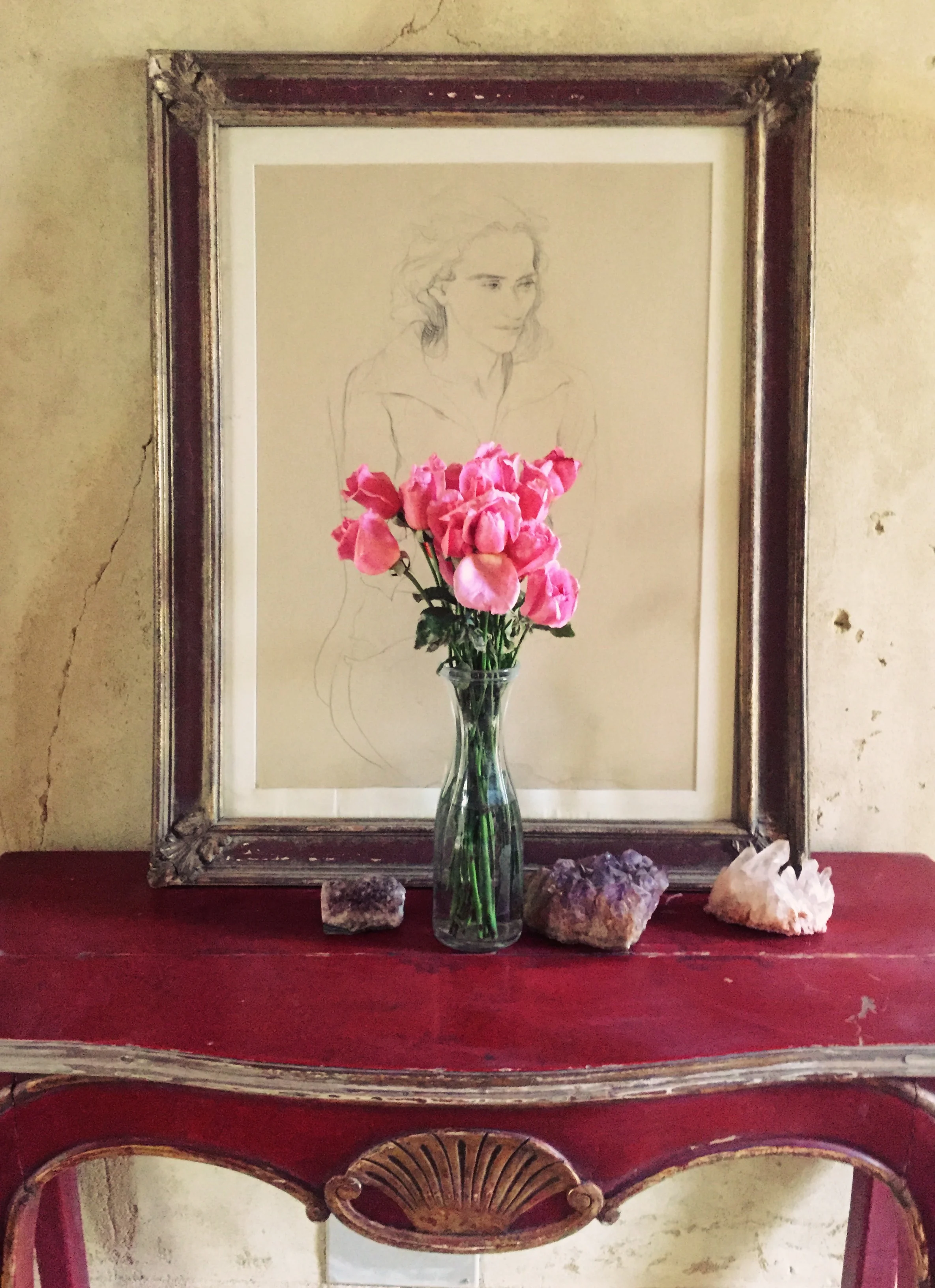 A drawing in the foyer of the house, Quartz and Amysthst crystals on the table and roses from Cairo.