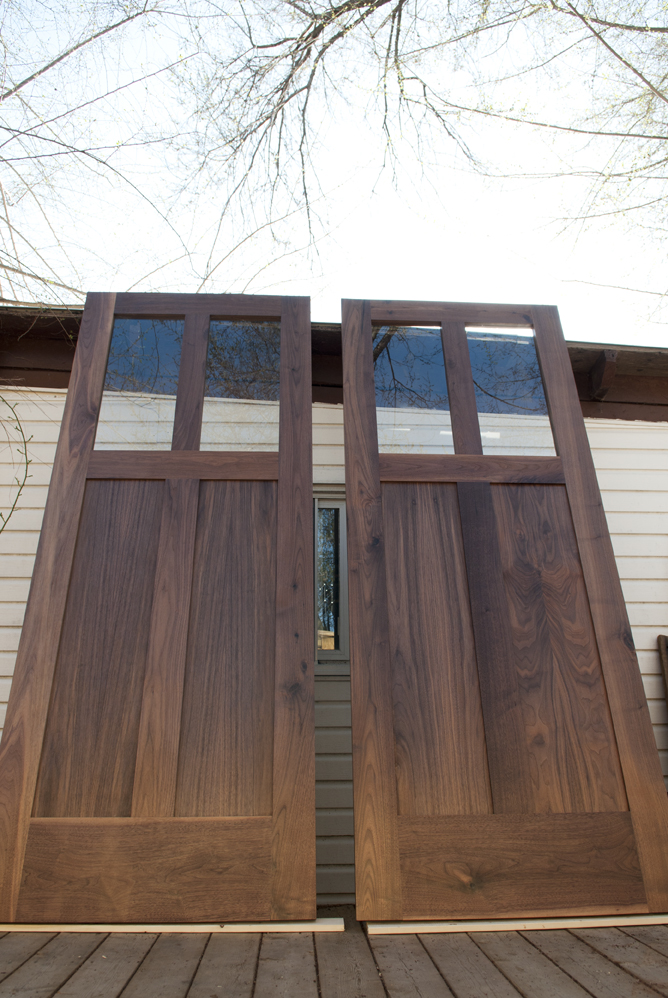 Walnut panel doors with glass upper. This is our Chicago door design.