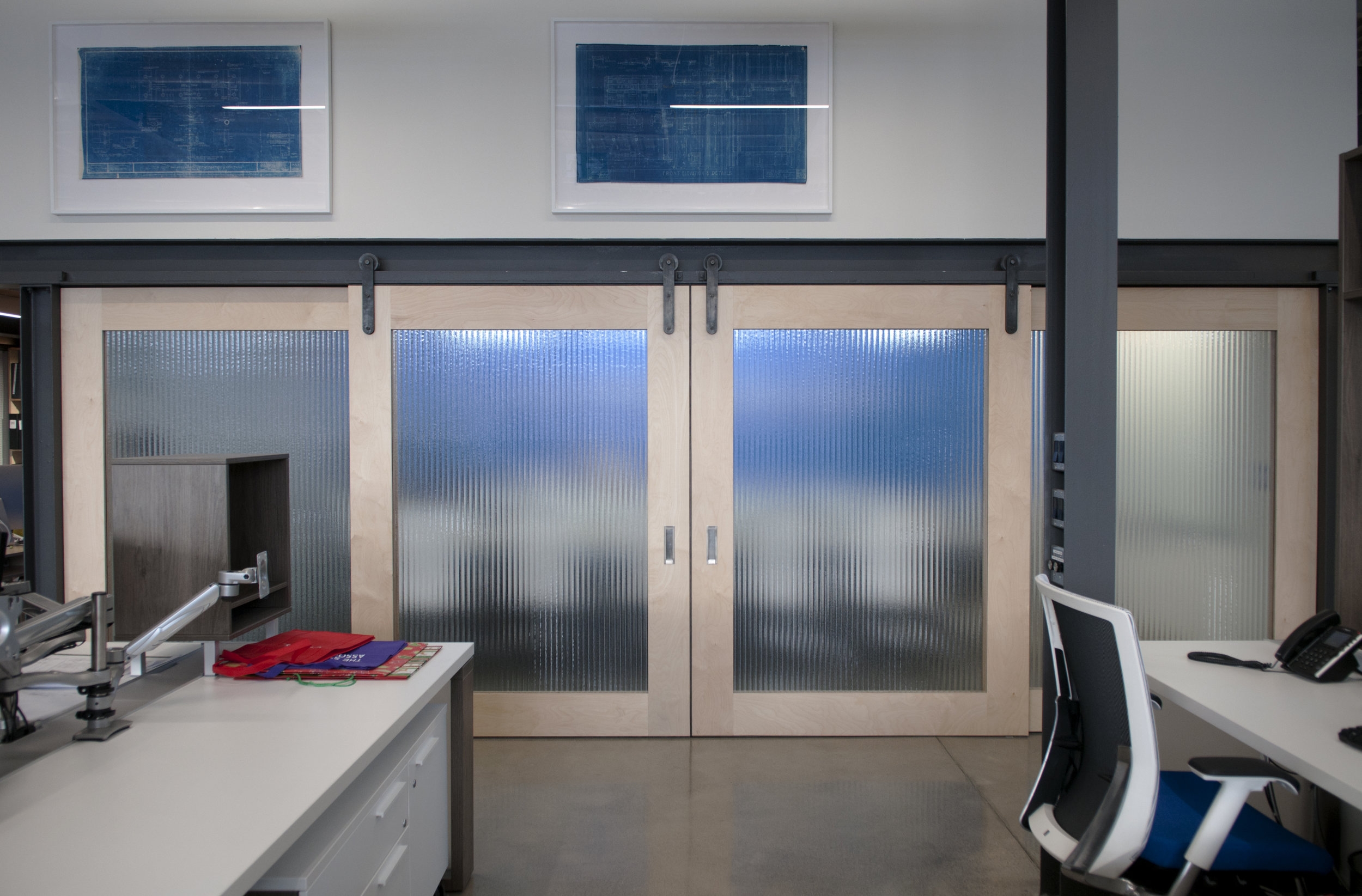 A more frontal view of the board room with the four doors. These doors slide on the existing I-beam!