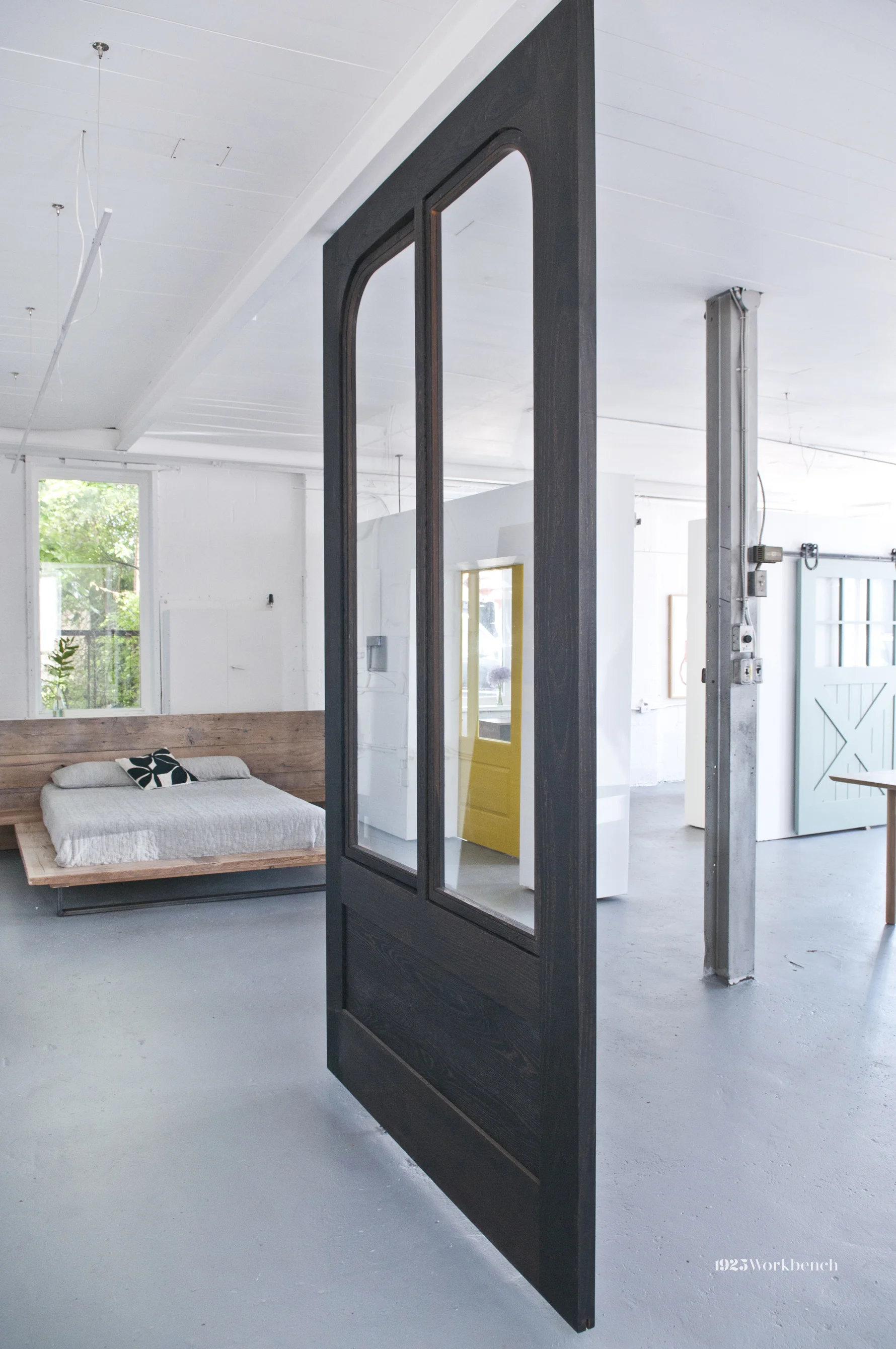 The big ebonized oak door slides on the I-beam that goes across the room. The windows open too, and that's what you saw in the picture above.