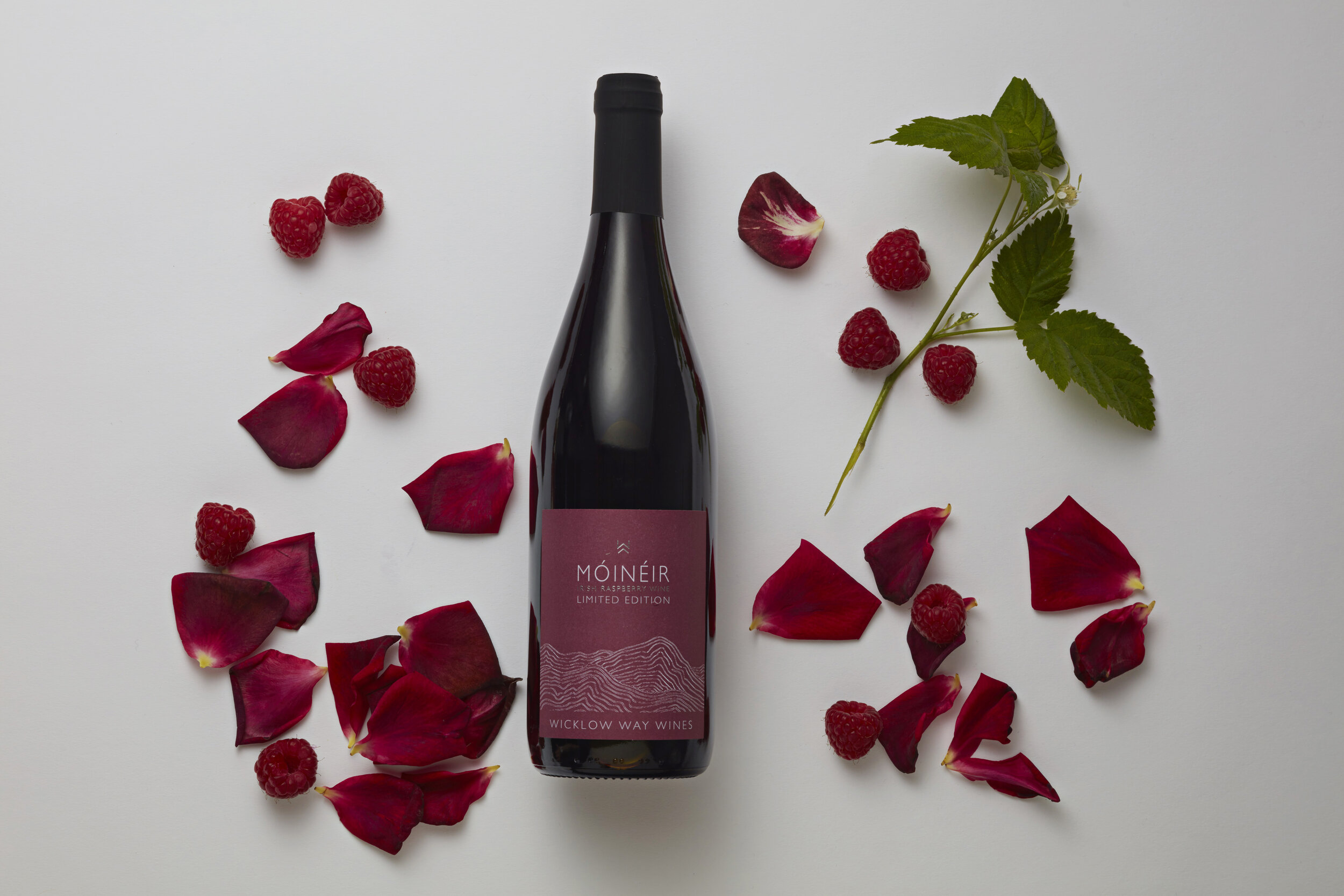 Raspberry wine bottle with petals.jpg