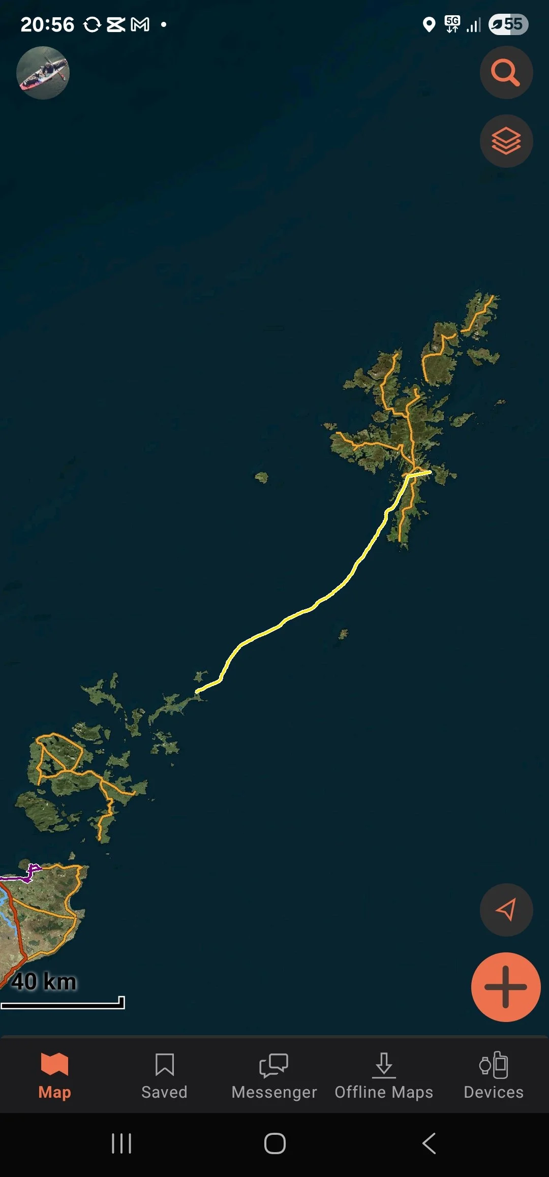 A digital map showing an archipelago with paths highlighted in yellow and orange, indicating routes. The map displays a large landmass with numerous smaller islands connected by these routes, all set against a dark blue water background.